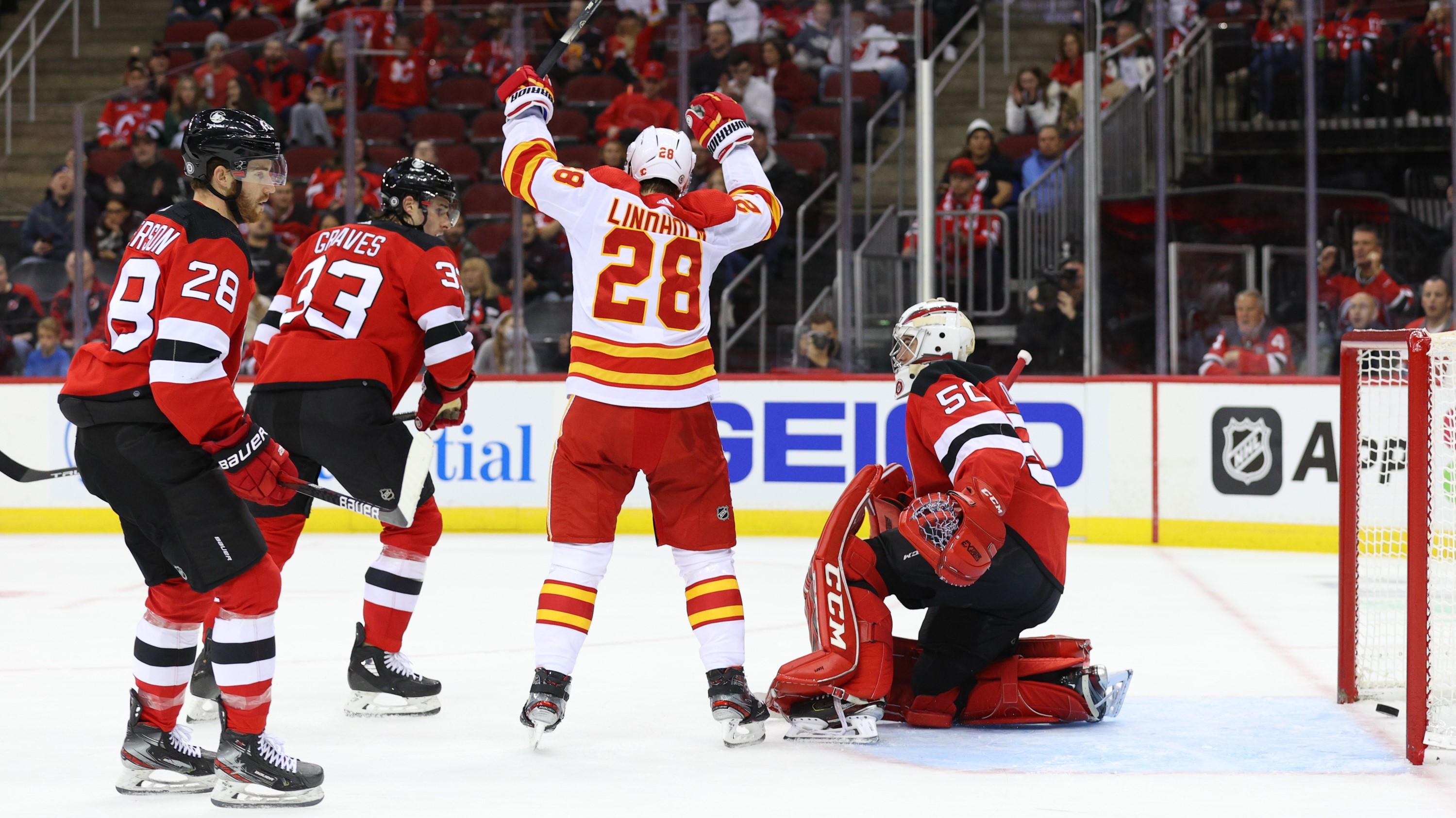 Oct 26, 2021; Newark, New Jersey, USA; Calgary Flames center Elias Lindholm (28) celebrates his goal on New Jersey Devils goaltender Nico Daws (50) during the first period at Prudential Center. Mandatory Credit: Ed Mulholland-USA TODAY Sports / Ed Mulholland-USA TODAY Sports