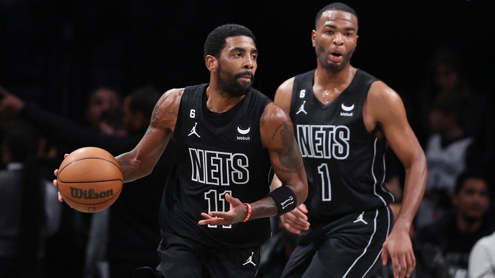 Brooklyn Nets guard Kyrie Irving (11) dribbles in front of forward T.J. Warren (1) during the first half against the Toronto Raptors / Vincent Carchietta-USA TODAY Sports