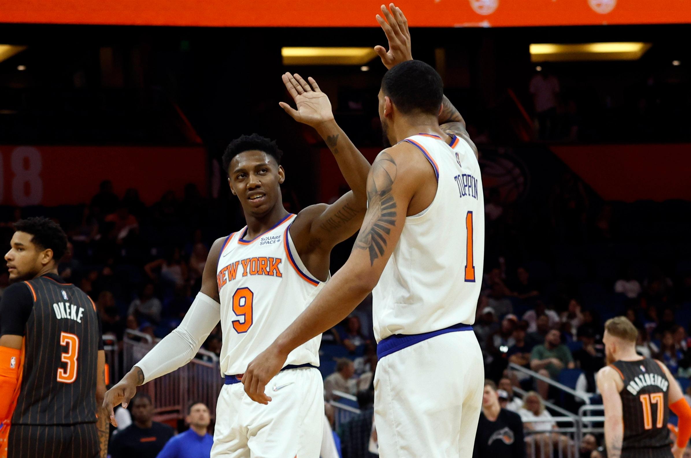 New York Knicks guard RJ Barrett (9) high fives New York Knicks forward Obi Toppin (1) against the Orlando Magic during the second quarter at Amway Center. / Kim Klement-USA TODAY Sports