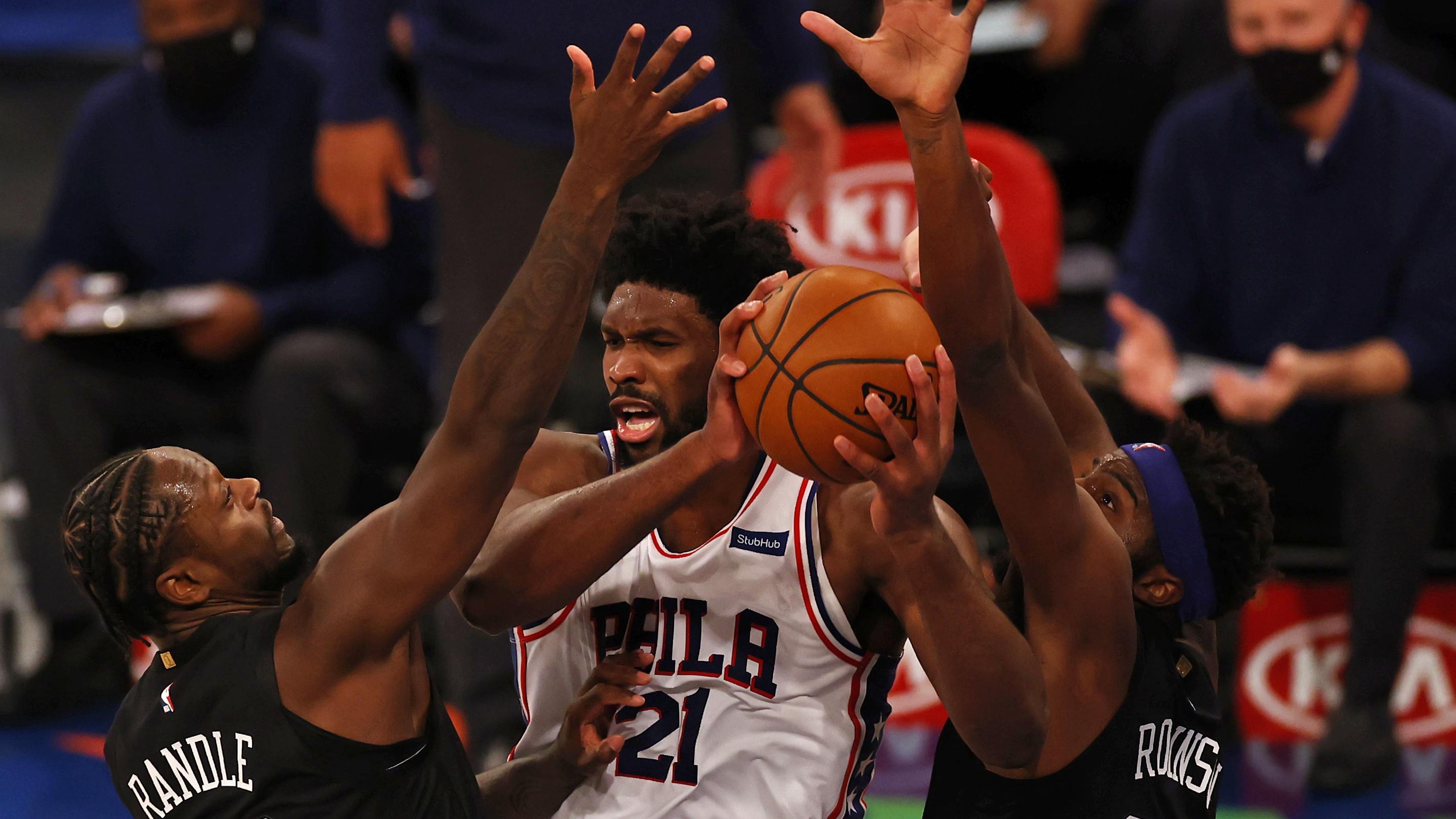 Dec 26, 2020; New York, New York, USA; Philadelphia 76ers center Joel Embiid (21) looks to pass between New York Knicks center Mitchell Robinson (23) and forward Julius Randle (30) during the first half of an NBA basketball game Saturday, Dec. 26, 2020, in New York at Madison Square Garden. Mandatory Credit: Adam Hunger/Pool Photo-USA TODAY Sports / © POOL PHOTOS-USA TODAY Sports