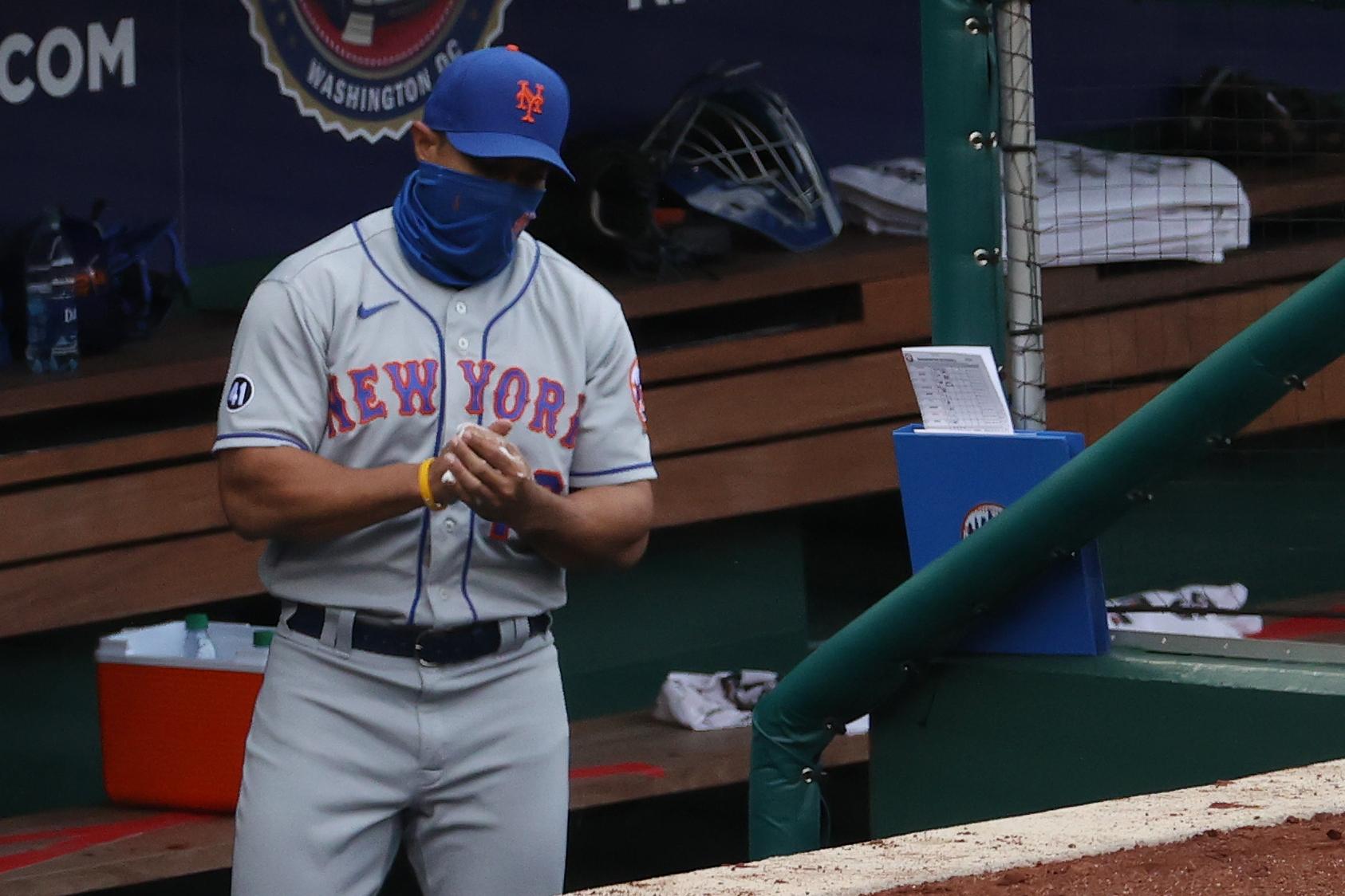 Sep 27, 2020; Washington, District of Columbia, USA; New York Mets manager Luis Rojas (19) uses hand sanitizer in the dugout after making a pitching change against the Washington Nationals in the second inning at Nationals Park / Geoff Burke-USA TODAY Sports