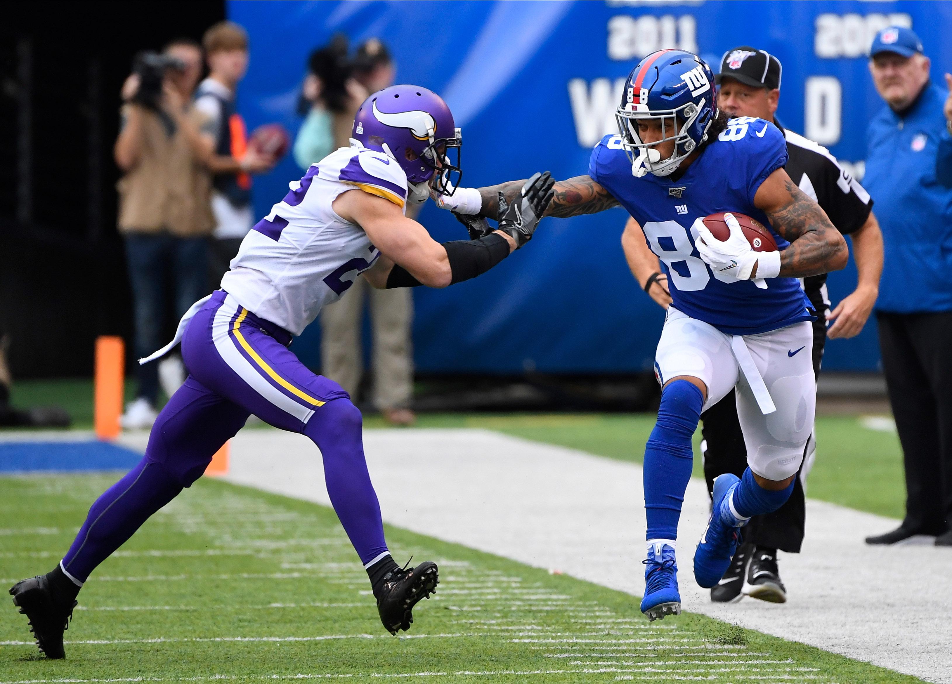 Oct 6, 2019; East Rutherford, NJ, USA; New York Giants tight end Evan Engram (88) gets a first down in the first quarter as Minnesota Vikings free safety Harrison Smith (22) defends at MetLife Stadium. / Robert Deutsch-USA TODAY Sports