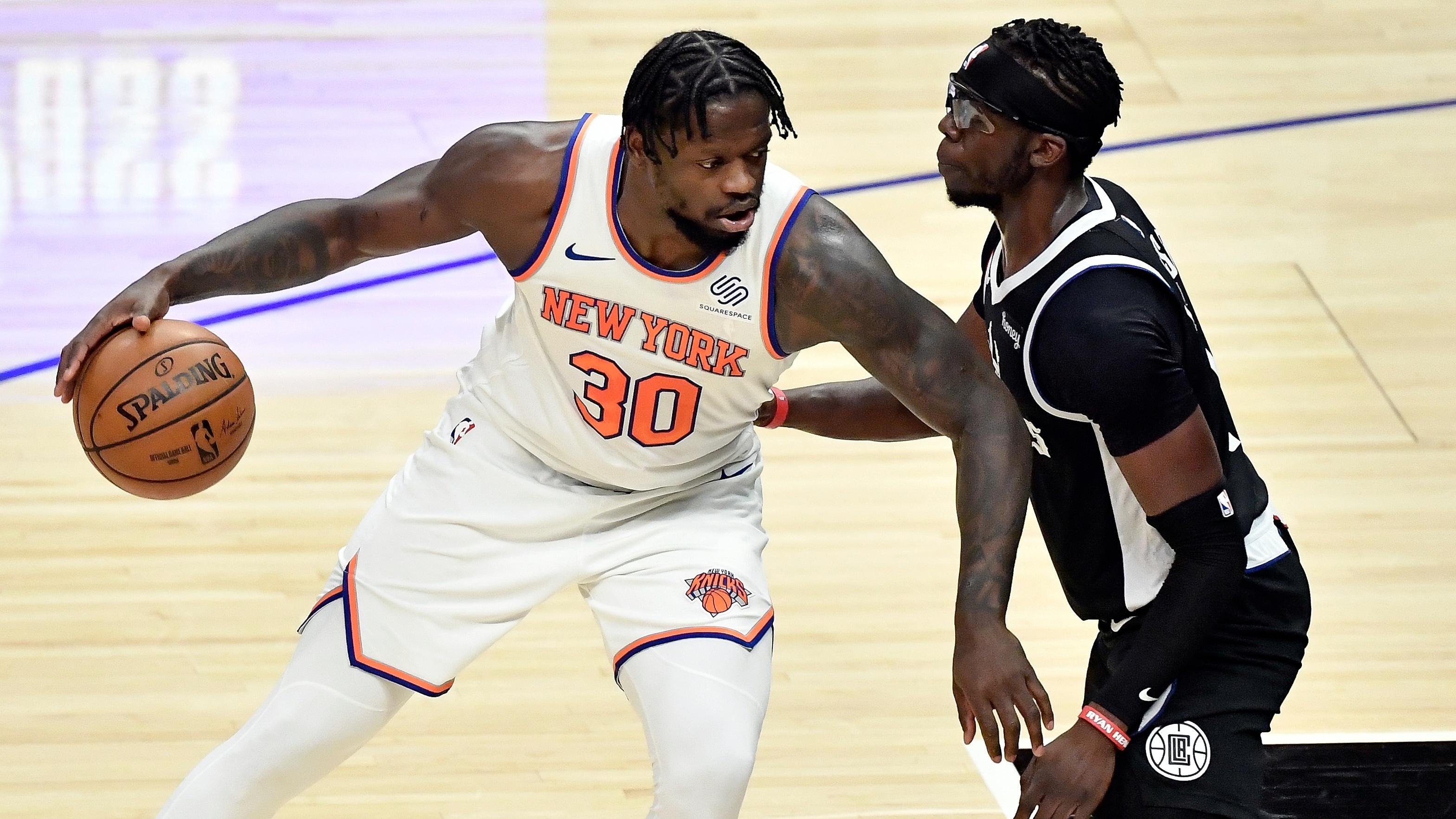 May 9, 2021; Los Angeles, California, USA; New York Knicks forward Julius Randle (30) dribbles to ball as LA Clippers guard Reggie Jackson (1) defends during the first quarter at Staples Center. / © Robert Hanashiro-USA TODAY Sports