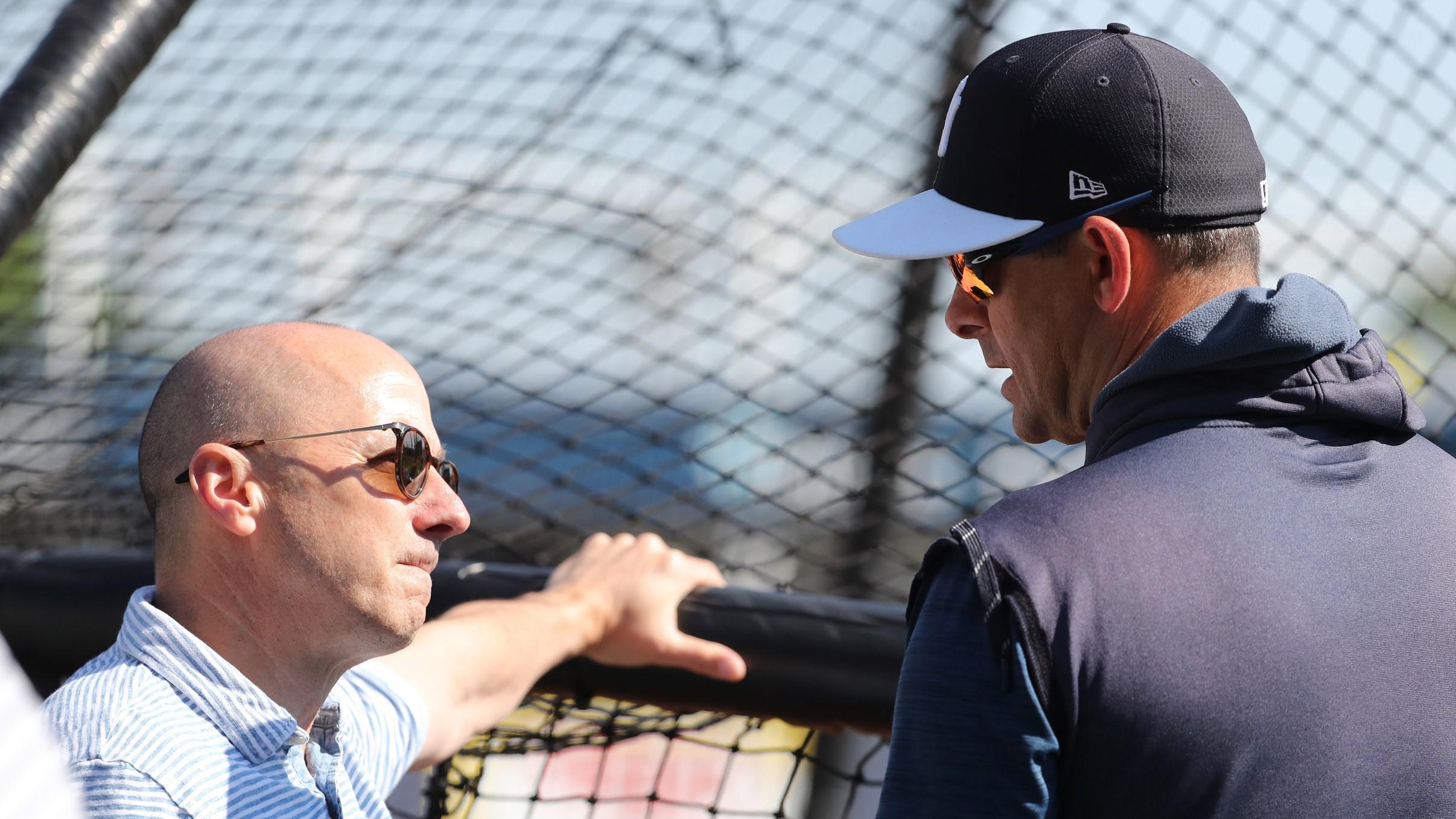 Mar 23, 2019; Tampa, FL, USA; New York Yankees general manager Brian Cashman (left) and manager Aaron Boone (17) talk prior to the game against the Toronto Blue Jays at George M. Steinbrenner Field. / Kim Klement-USA TODAY Sports