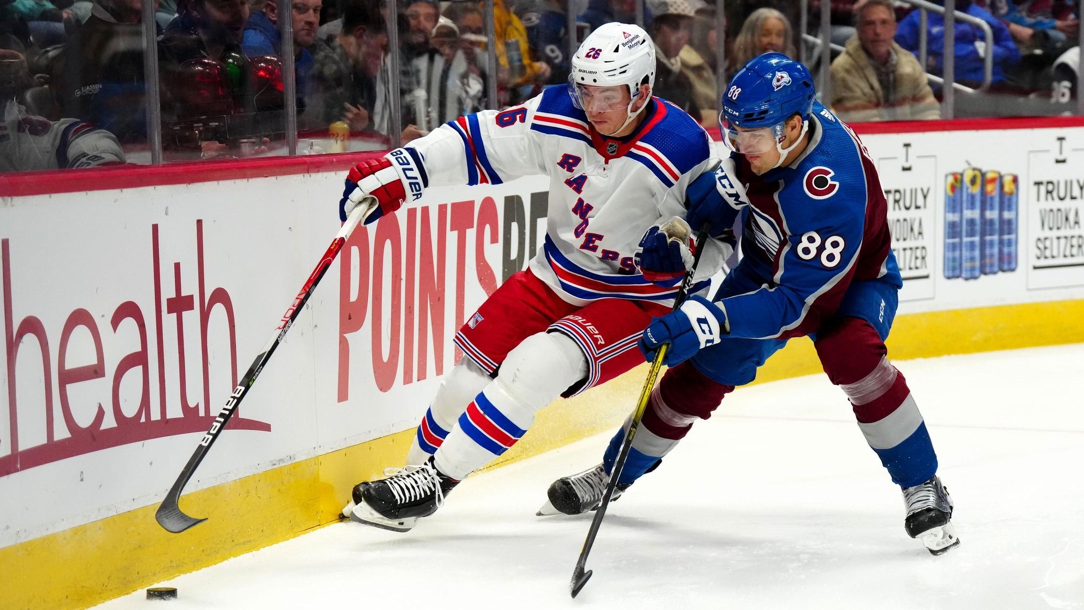 Dec 9, 2022; Denver, Colorado, USA; New York Rangers left wing Jimmy Vesey (26) and Colorado Avalanche defenseman Andreas Englund (88) battle for control of the puck in the first period at Ball Arena. / Ron Chenoy-USA TODAY Sports