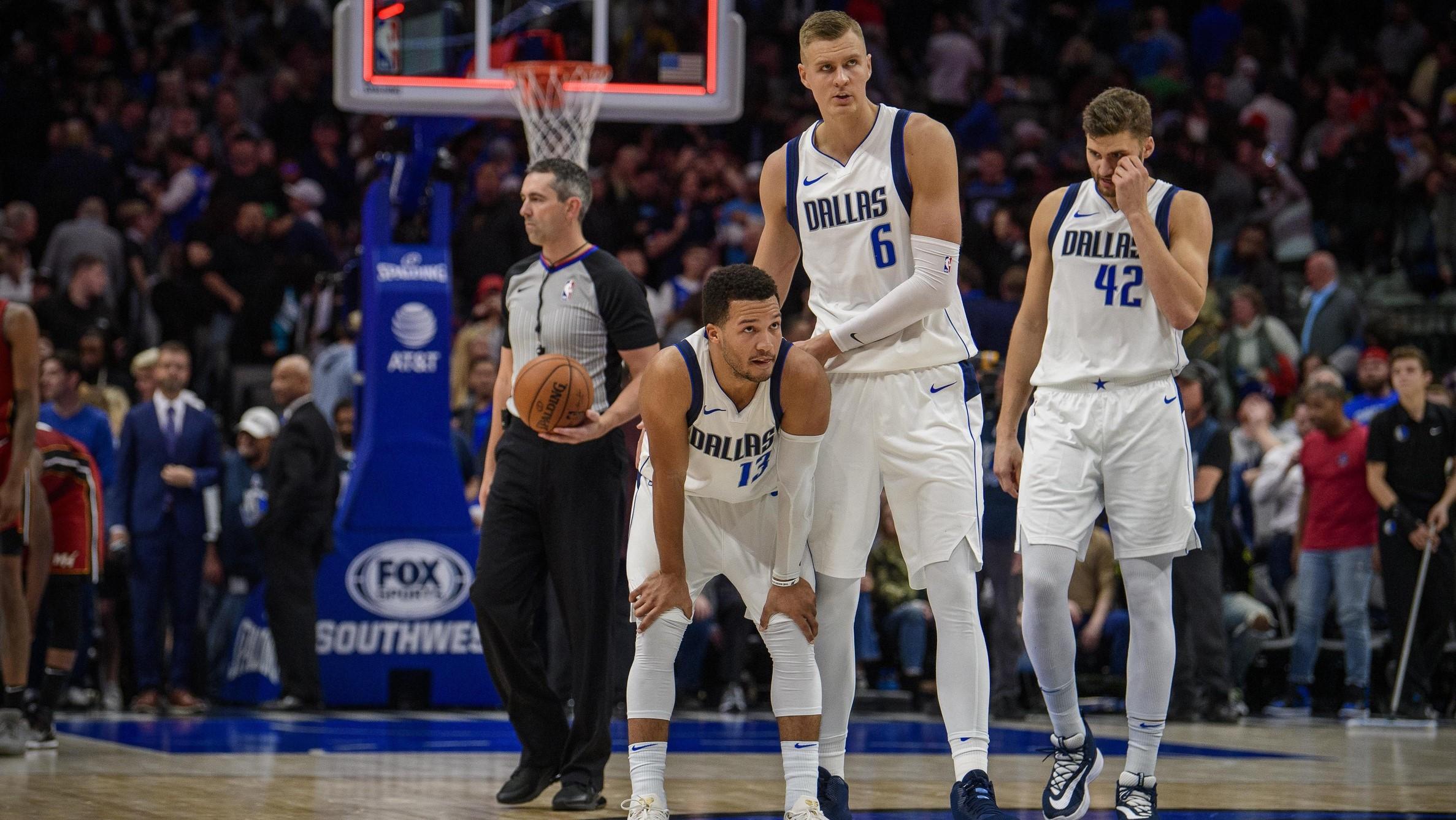 Dec 14, 2019; Dallas, TX, USA; Dallas Mavericks forward Kristaps Porzingis (6) consoles guard Jalen Brunson (13) after Brunson misses a shot to tie the game against the Miami Heat during overtime at the American Airlines Center. / Jerome Miron-USA TODAY Sports