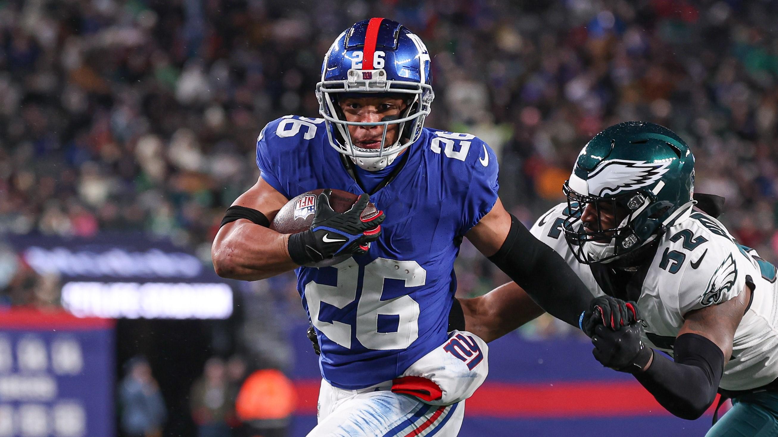 Jan 7, 2024; East Rutherford, New Jersey, USA; New York Giants running back Saquon Barkley (26) breaks a tackle by Philadelphia Eagles linebacker Zach Cunningham (52) for a rushing touchdown during the first half at MetLife Stadium. Mandatory Credit: Vincent Carchietta-USA TODAY Sports / © Vincent Carchietta-USA TODAY Sports