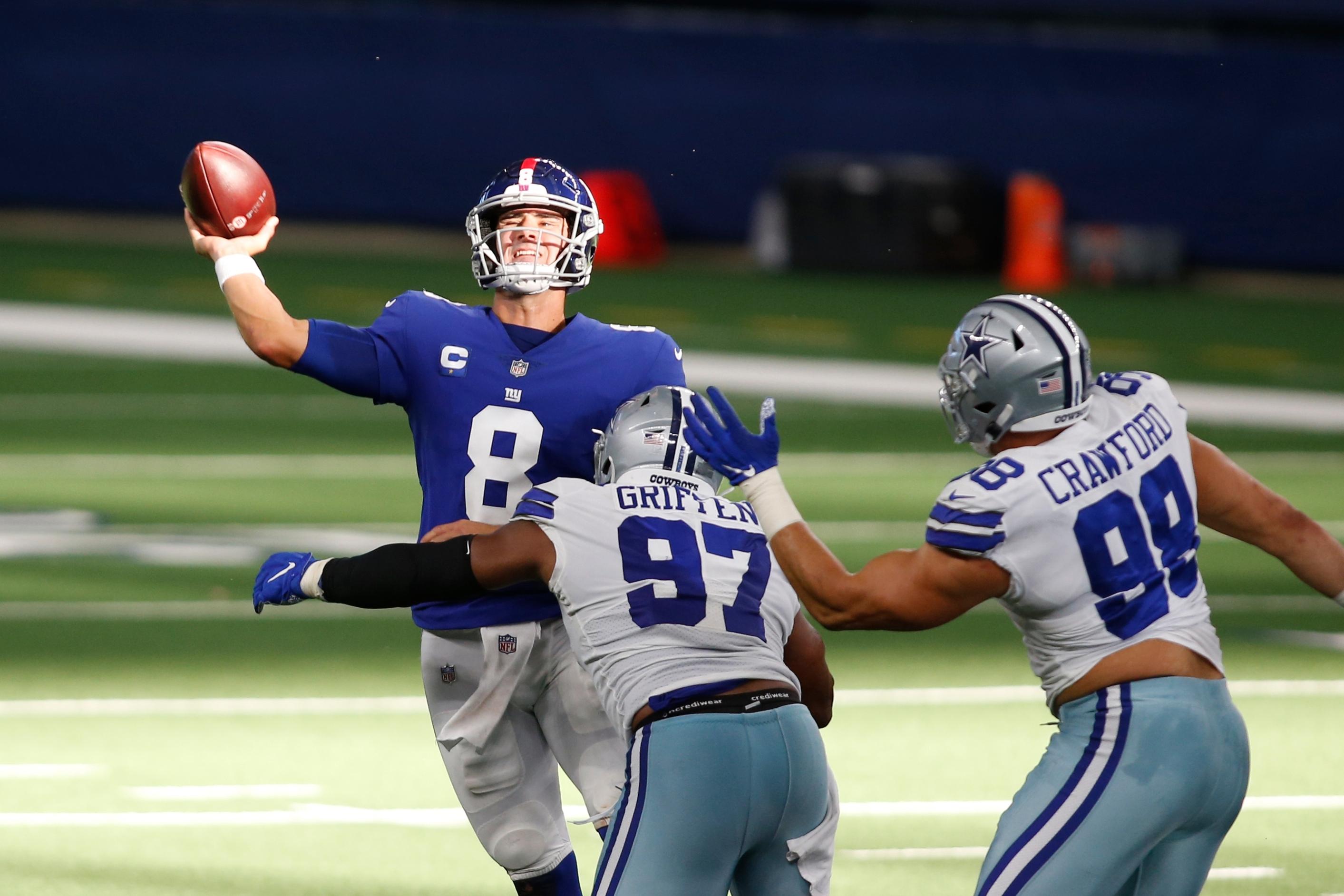 Oct 11, 2020; Arlington, Texas, USA; New York Giants quarterback Daniel Jones (8) throws the ball against Dallas Cowboys defensive end Everson Griffen (97) and defensive tackle Tyrone Crawford (98) in the third quarter at AT&T Stadium. / Tim Heitman-USA TODAY Sports