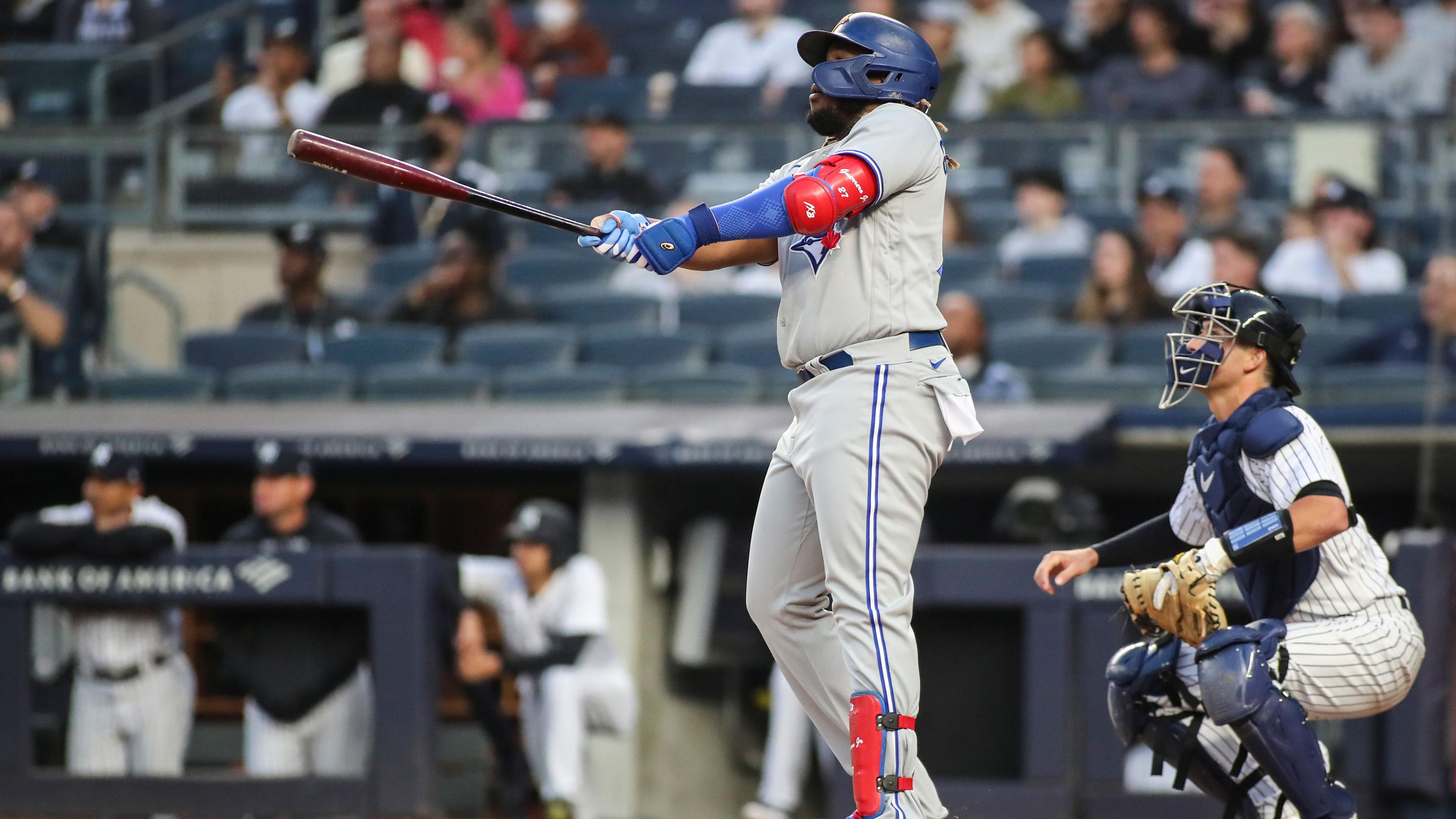 Apr 13, 2022; Bronx, New York, USA; Toronto Blue Jays first baseman Vladimir Guerrero Jr. (27) hits a solo home run in the first inning against the New York Yankees at Yankee Stadium. / Wendell Cruz-USA TODAY Sports