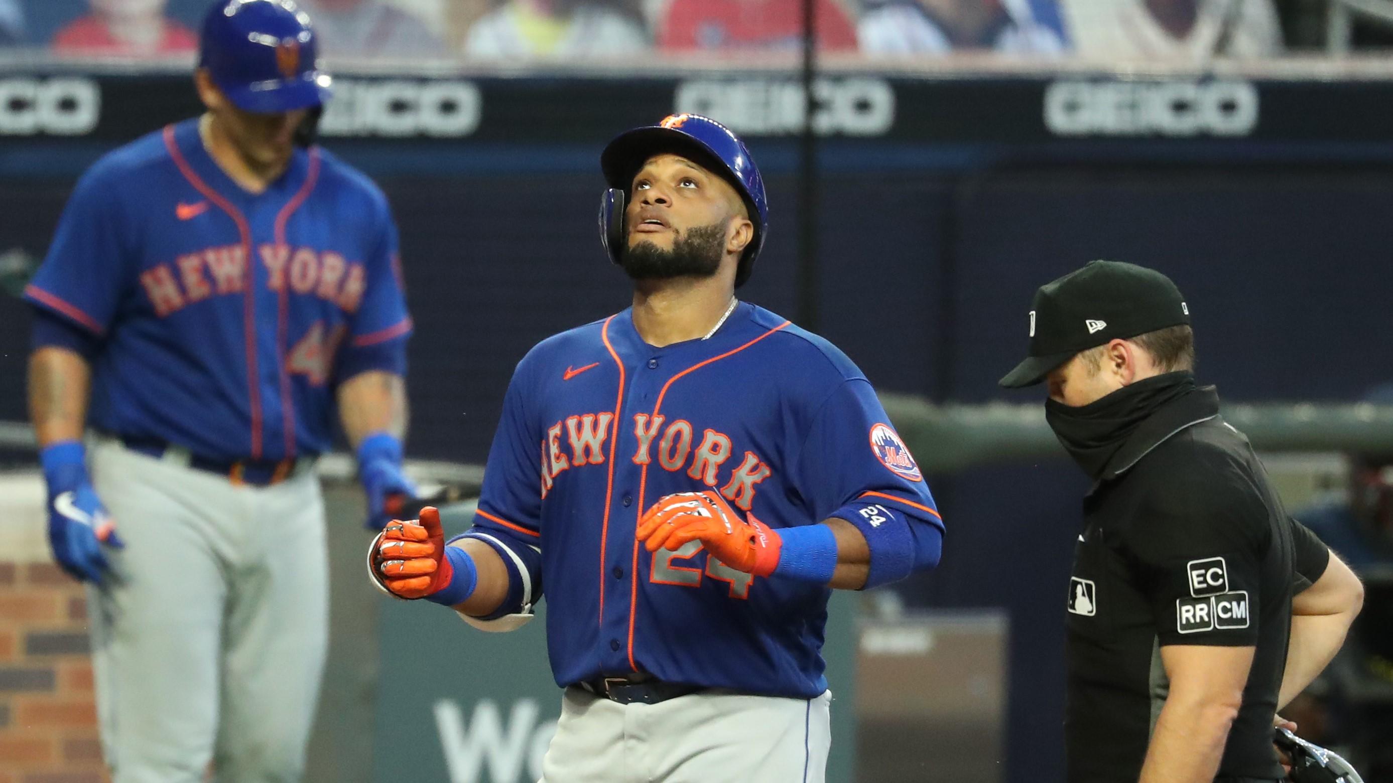 New York Mets second baseman Robinson Cano (24) reacts after his solo home run in the fifth inning against the Atlanta Braves at Truist Park. / Jason Getz