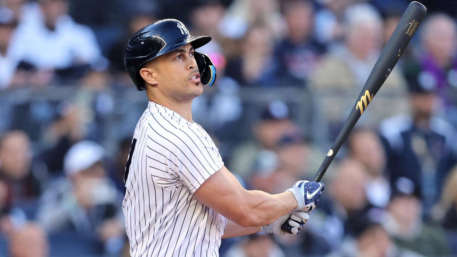 Oct 18, 2022; Bronx, New York, USA; New York Yankees designated hitter Giancarlo Stanton (27) hits a three-run home run against the Cleveland Guardians during the first inning in game five of the ALDS for the 2022 MLB Playoffs at Yankee Stadium. / Brad Penner-USA TODAY Sports