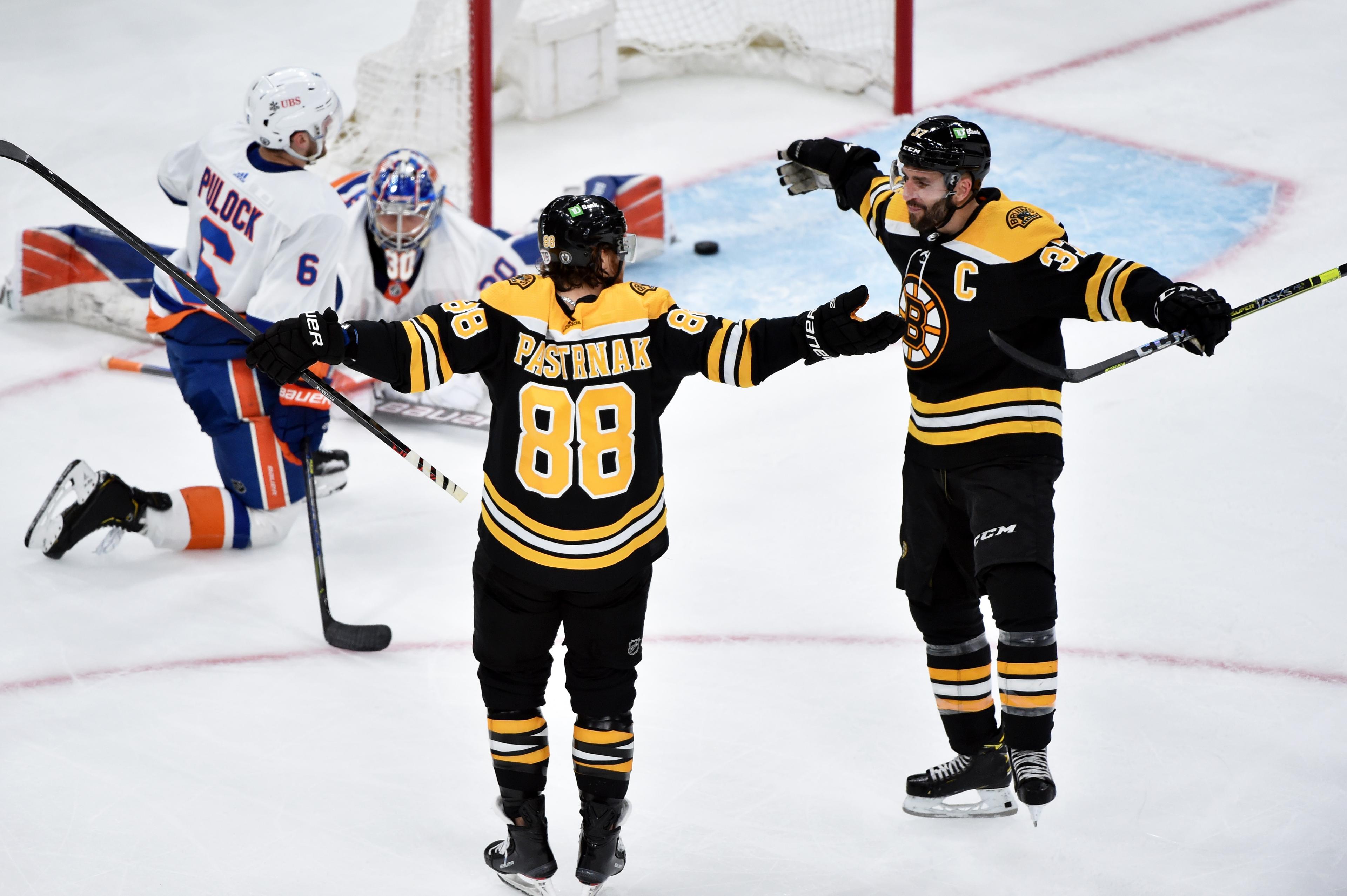 May 29, 2021; Boston, MA, USA; Boston Bruins right wing David Pastrnak (88) reacts with center Patrice Bergeron (37) after scoring his second goal of the game during the second period in game one of the second round of the 2021 Stanley Cup Playoffs against the New York Islanders at TD Garden. Mandatory Credit: Bob DeChiara-USA TODAY Sports / Bob DeChiara-USA TODAY Sports