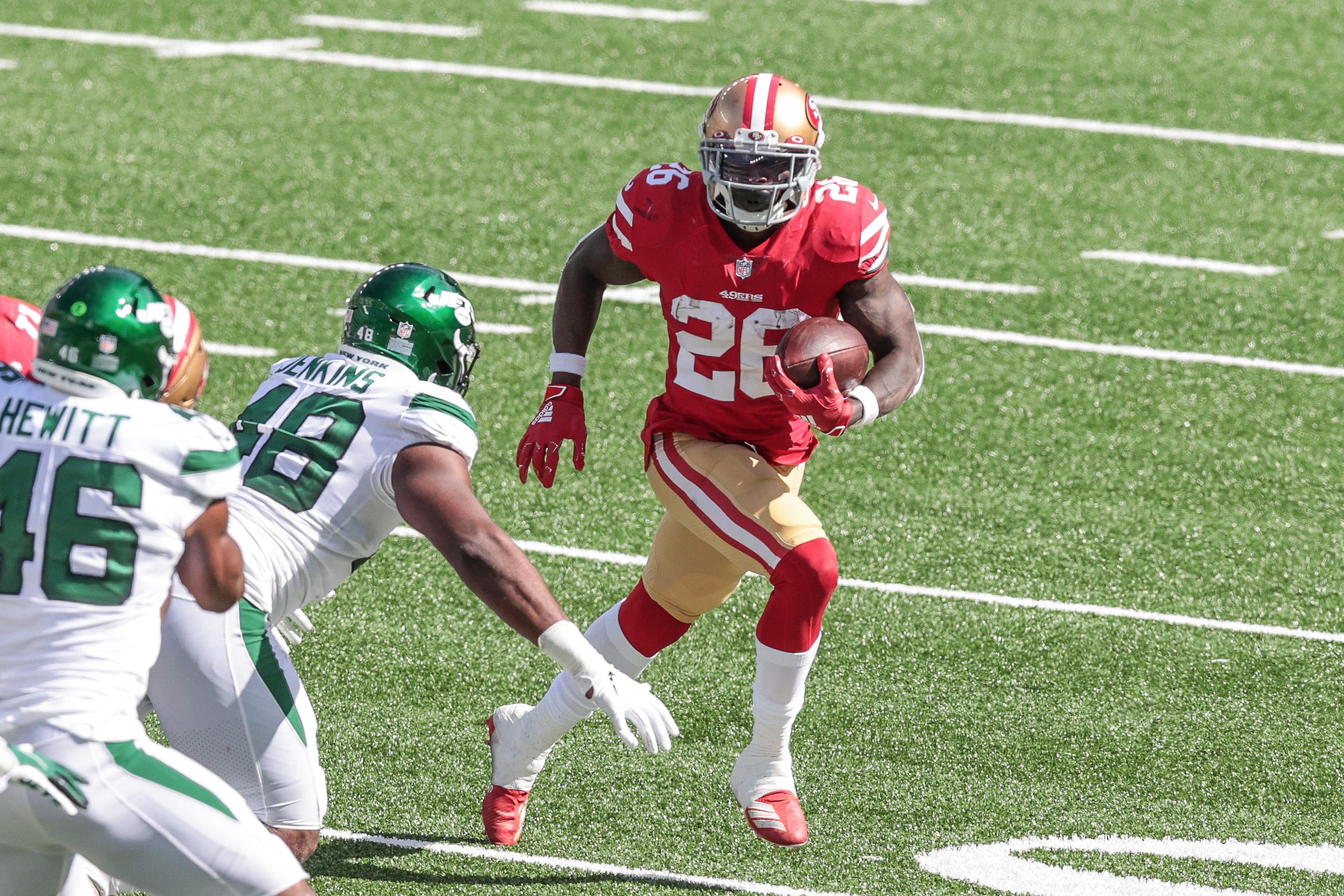 Sep 20, 2020; East Rutherford, New Jersey, USA; San Francisco 49ers running back Tevin Coleman (26) carries the ball as New York Jets outside linebacker Jordan Jenkins (48) defends during the second half at MetLife Stadium. Mandatory Credit: Vincent Carchietta-USA TODAY Sports / © Vincent Carchietta-USA TODAY Sports