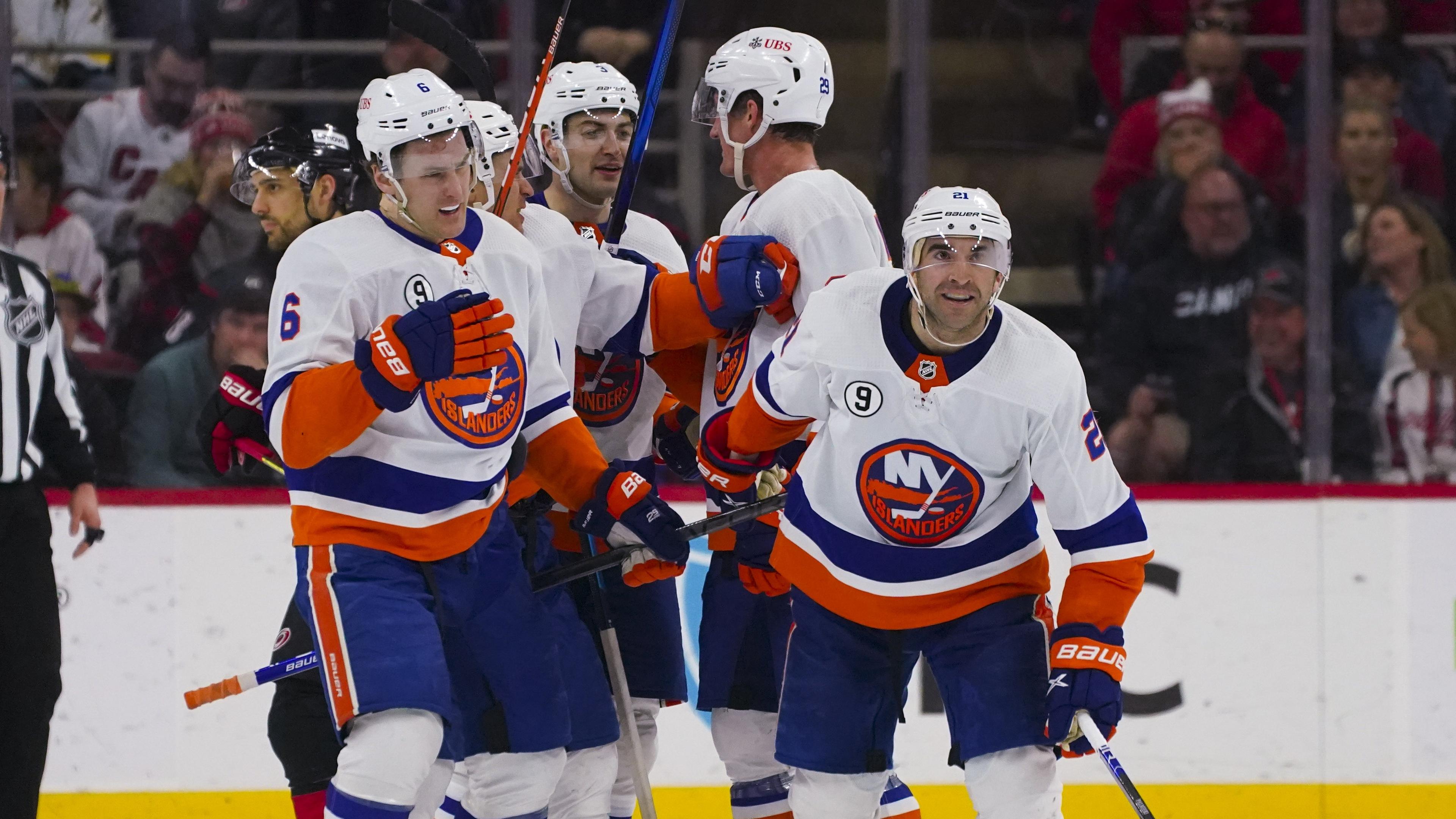 Apr 8, 2022; Raleigh, North Carolina, USA; New York Islanders right wing Kyle Palmieri (21) is congratulated by defenseman Ryan Pulock (6) center Brock Nelson (29) defenseman Adam Pelech (3) and left wing Zach Parise (11) after his goal against the Carolina Hurricanes during the third period at PNC Arena. Mandatory Credit: James Guillory-USA TODAY Sports / © James Guillory-USA TODAY Sports