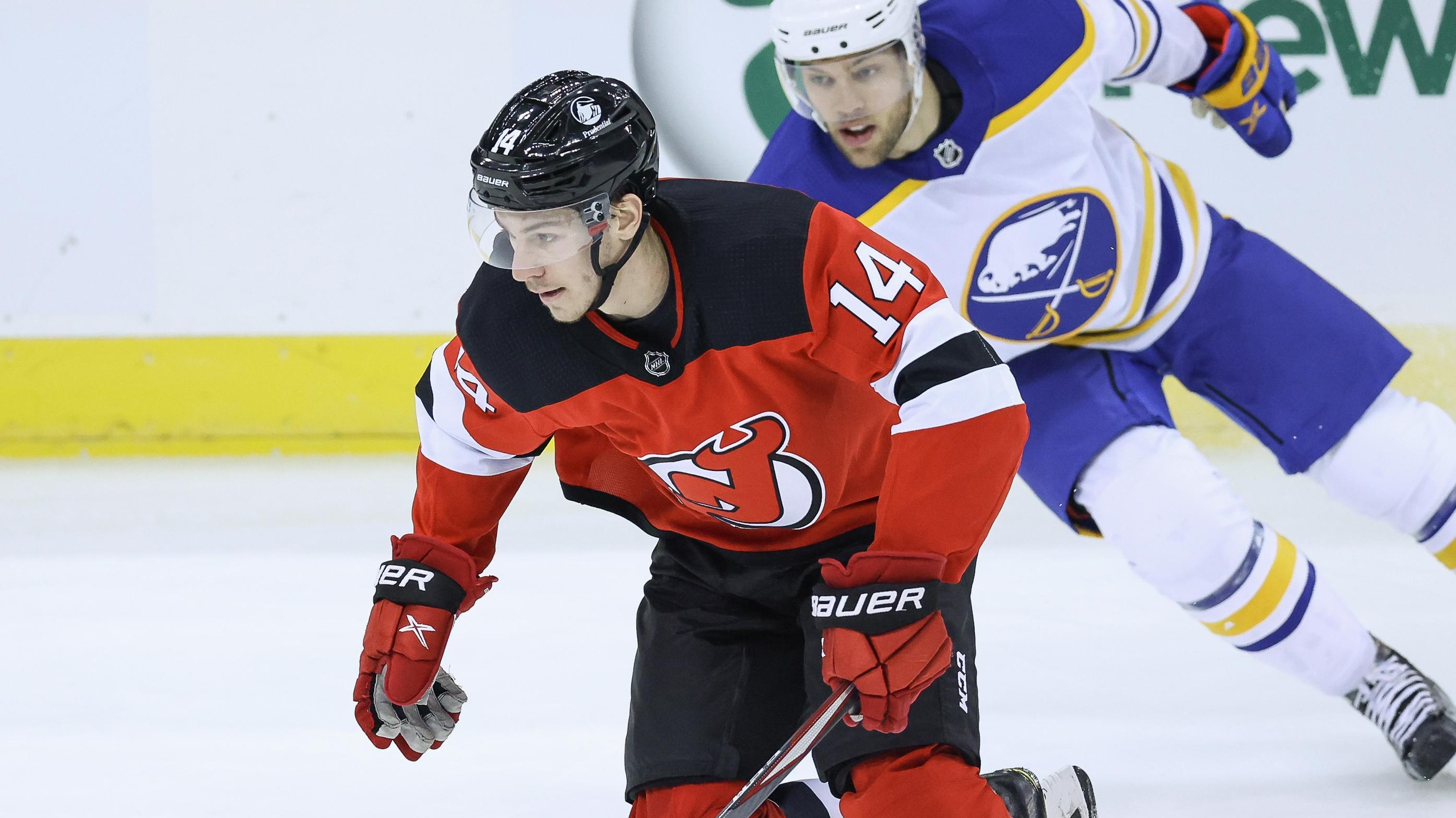 New Jersey Devils right wing Nathan Bastian (14) skates the puck up ice against Buffalo Sabres left wing Taylor Hall (4) during the first period at Prudential Center. / Vincent Carchietta-USA TODAY Sports