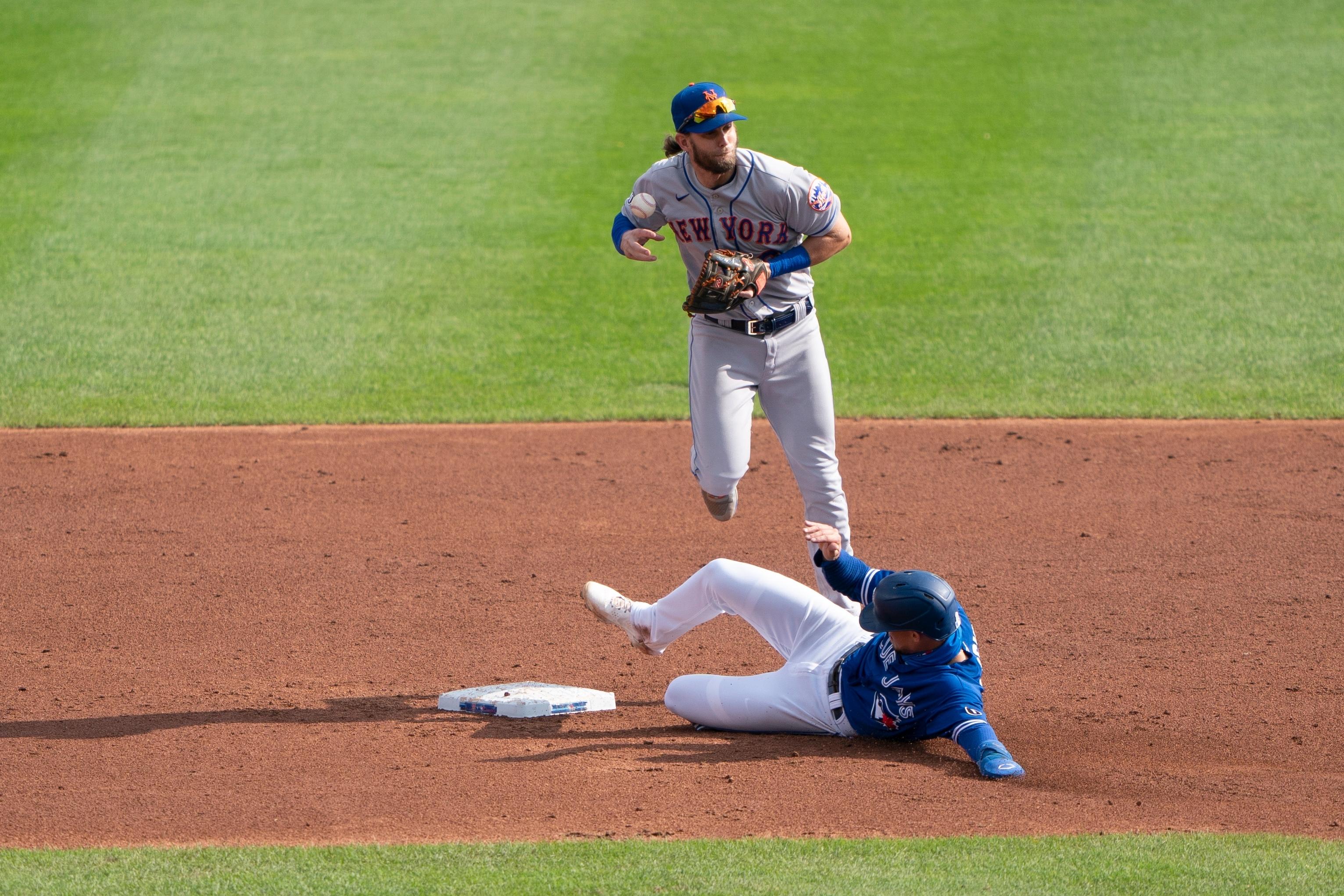 Sep 13, 2020; Buffalo, New York, USA; Toronto Blue Jays third baseman Cavan Biggio (8) slides into second base and disrupts New York Mets second baseman Jeff McNeil (6) from completing a double play during the third inning at Sahlen Field. / © Gregory Fisher-USA TODAY Sports