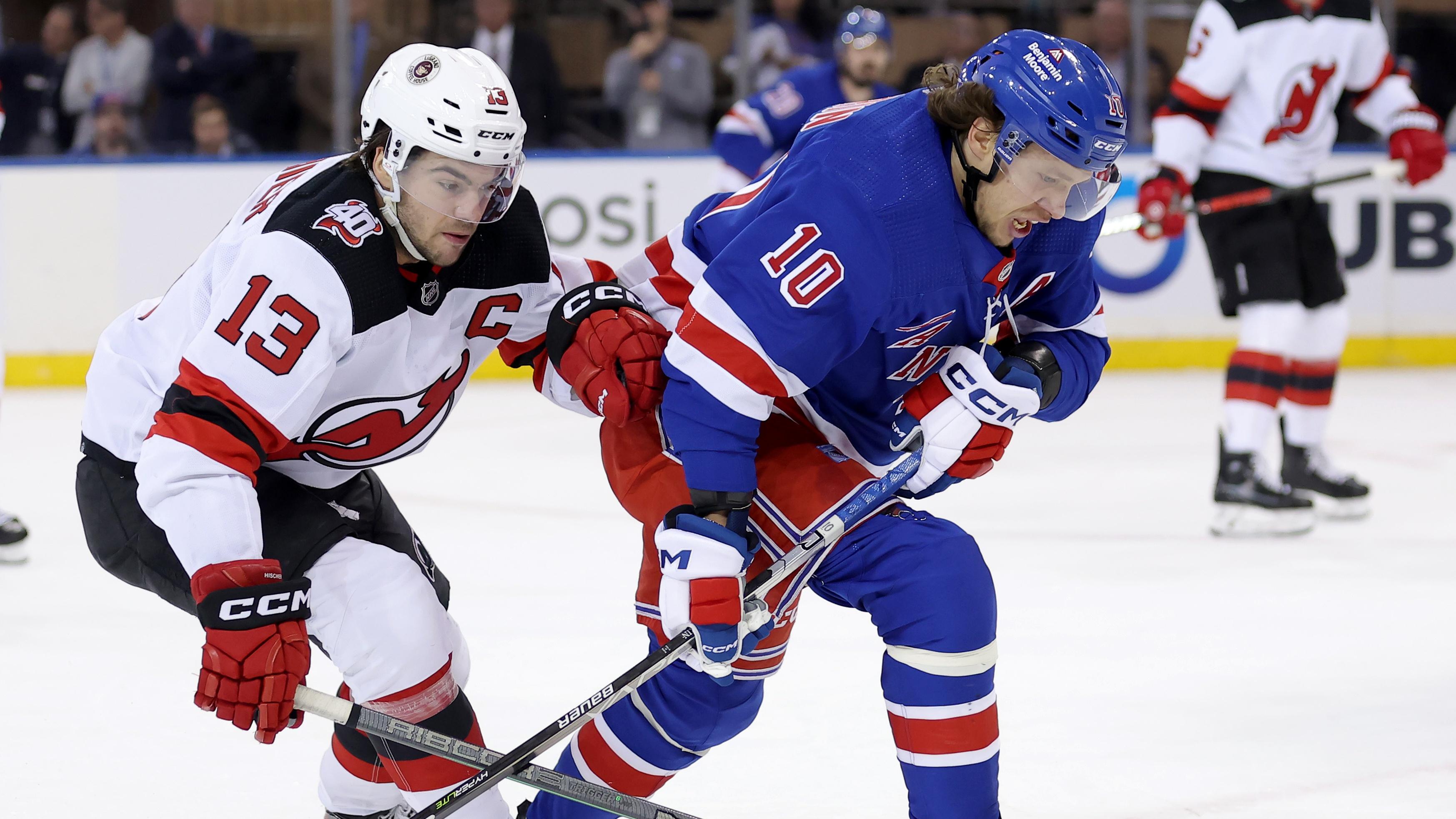 New York Rangers left wing Artemi Panarin (10) fights for the puck against New Jersey Devils center Nico Hischier (13) during the first period in game four of the first round of the 2023 Stanley Cup Playoffs at Madison Square Garden / Brad Penner - USA TODAY Sports