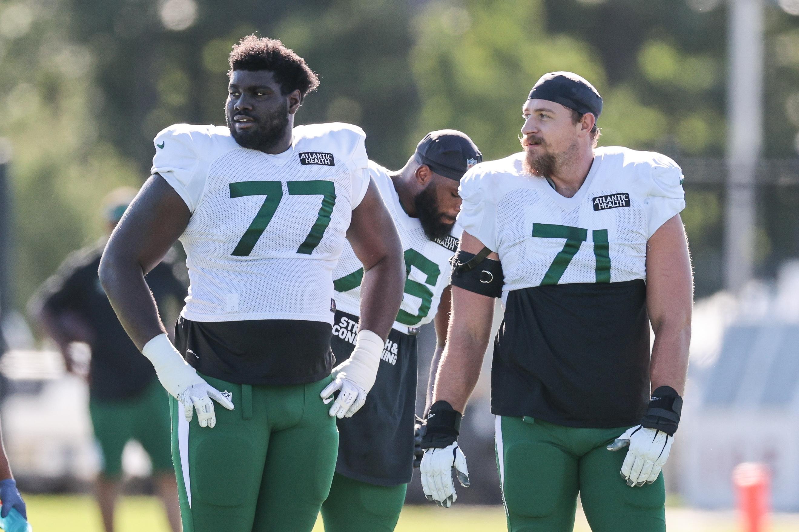 Aug 20, 2020; Florham Park, New Jersey, USA; New York Jets offensive tackle Mekhi Becton (77) and guard Alex Lewis (71) look on during training camp at Atlantic Health Center. Mandatory Credit: Vincent Carchietta-USA TODAY Sports / Vincent Carchietta-USA TODAY Sports