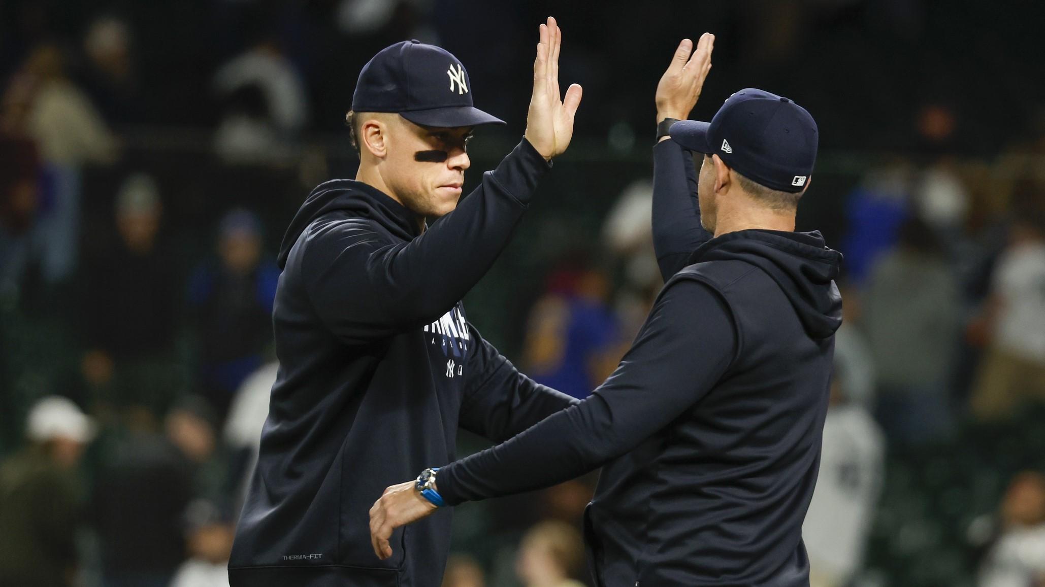 May 30, 2023; Seattle, Washington, USA; New York Yankees center fielder Aaron Judge (99, left) and manager Aaron Boone (17) high five following a 10-2 victory against the Seattle Mariners at T-Mobile Park. / Joe Nicholson-USA TODAY Sports