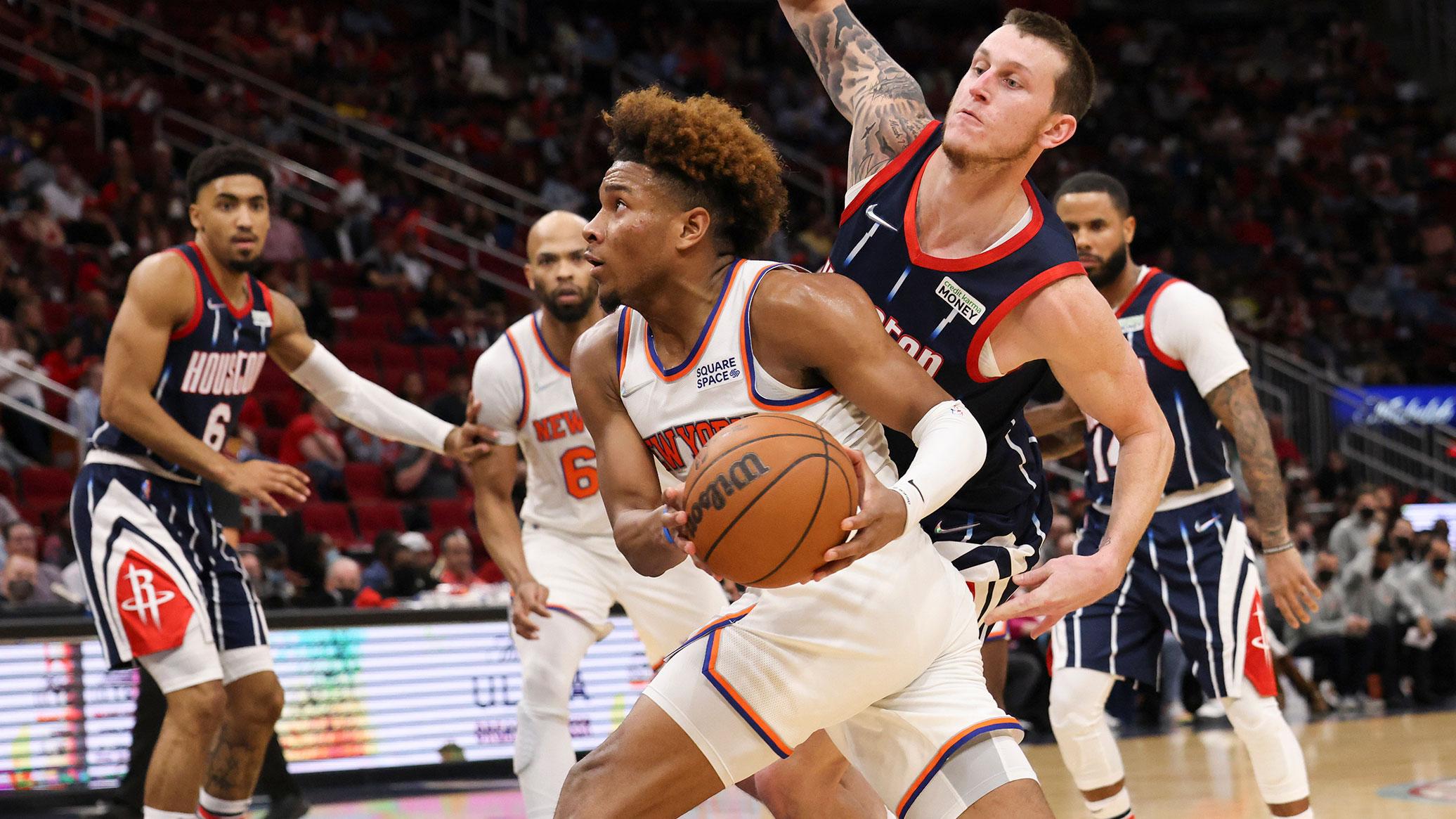 New York Knicks guard Miles McBride (2) dribbles past Houston Rockets guard Garrison Mathews (25) in the third quarter at Toyota Center. / Thomas Shea-USA TODAY Sports