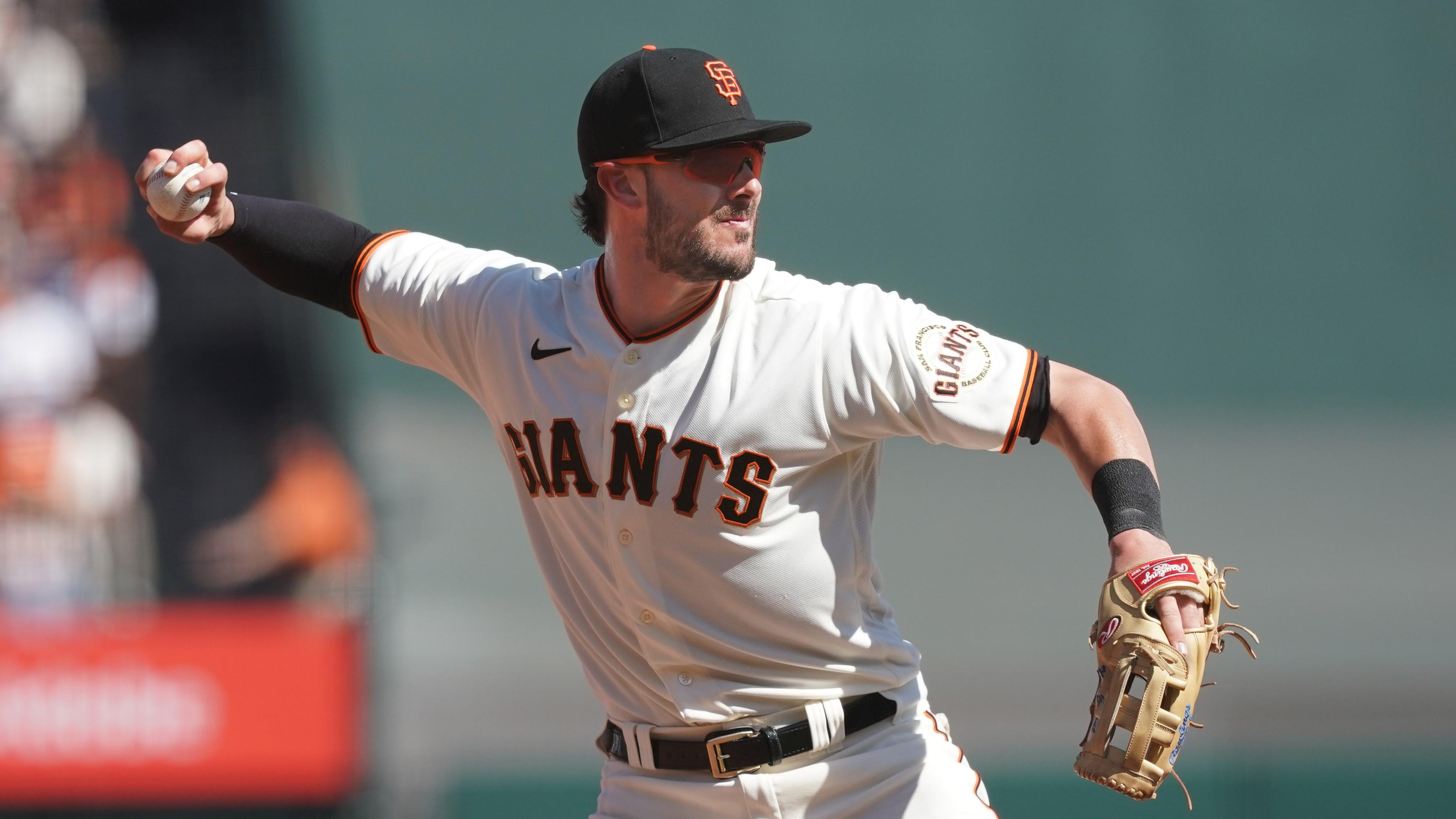 San Francisco Giants third baseman Kris Bryant (23) throws the ball to first base to record an out during the fourth inning against the San Diego Padres at Oracle Park. / Darren Yamashita-USA TODAY Sports
