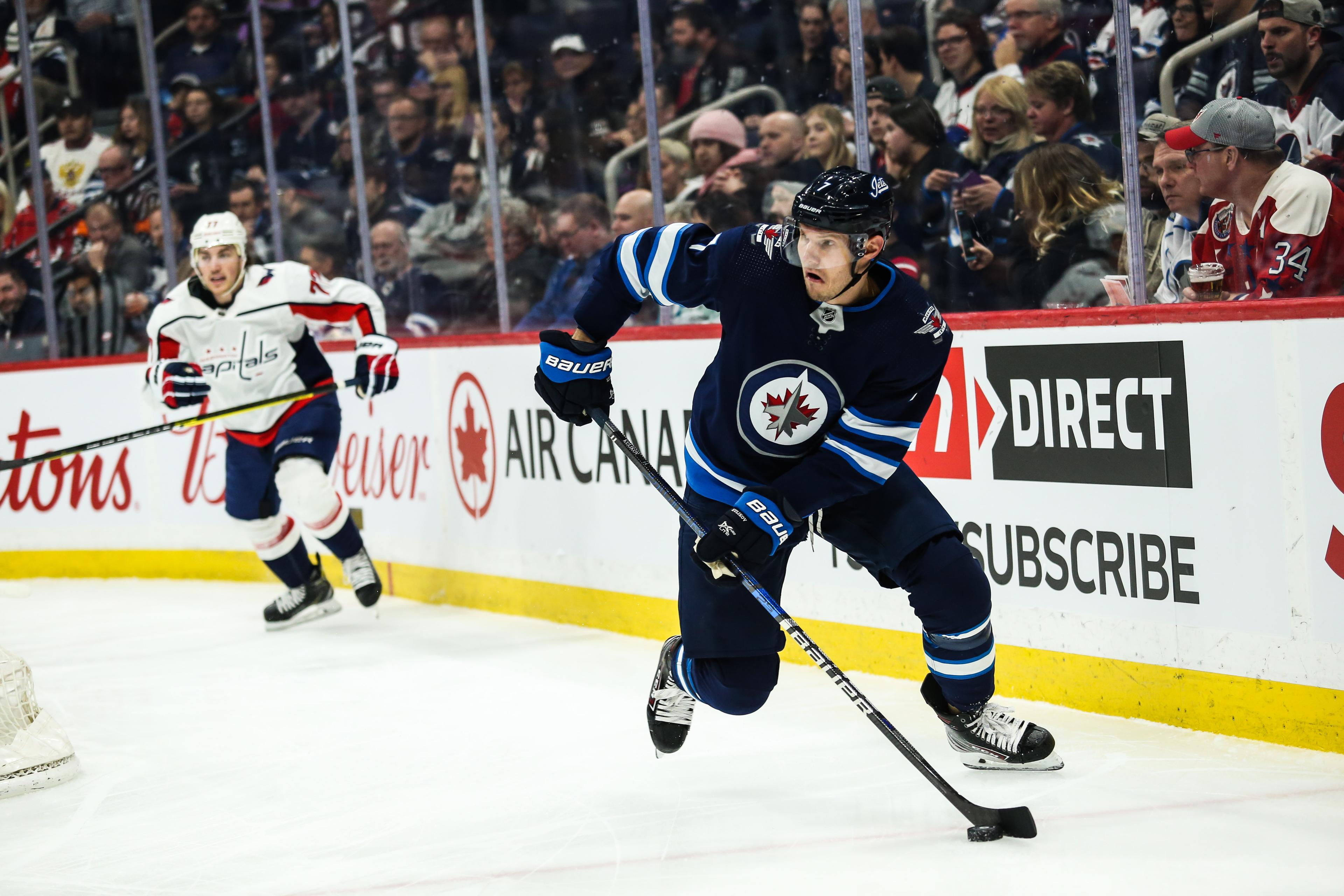 Winnipeg Jets defenseman Dmitry Kulikov (7) looks lo make a pass against the Washington Capitals during the first period at Bell MTS Place. / Terrence Lee - USA Today Sports