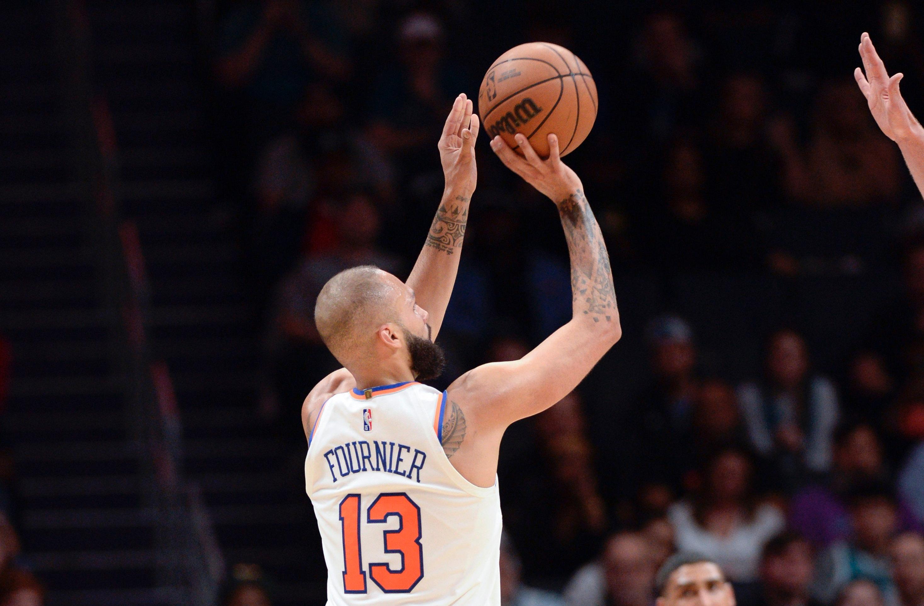 New York Knicks guard forward Evan Fournier (13) shoots and makes a three point shot that makes him the all time three point scorer in franchise history during the second half against the Charlotte Hornets at the Spectrum Center / Sam Sharpe-USA TODAY Sports