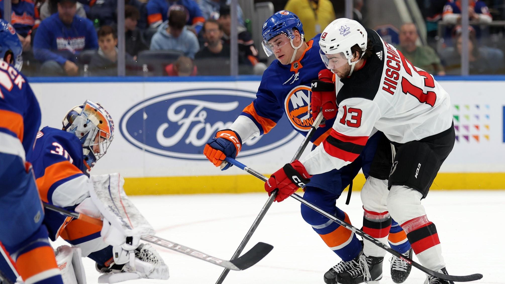 Oct 20, 2023; Elmont, New York, USA; New Jersey Devils center Nico Hischier (13) takes a shot against New York Islanders goaltender Ilya Sorokin (30) and defenseman Alexander Romanov (28) during the first period at UBS Arena. / Brad Penner-USA TODAY Sports