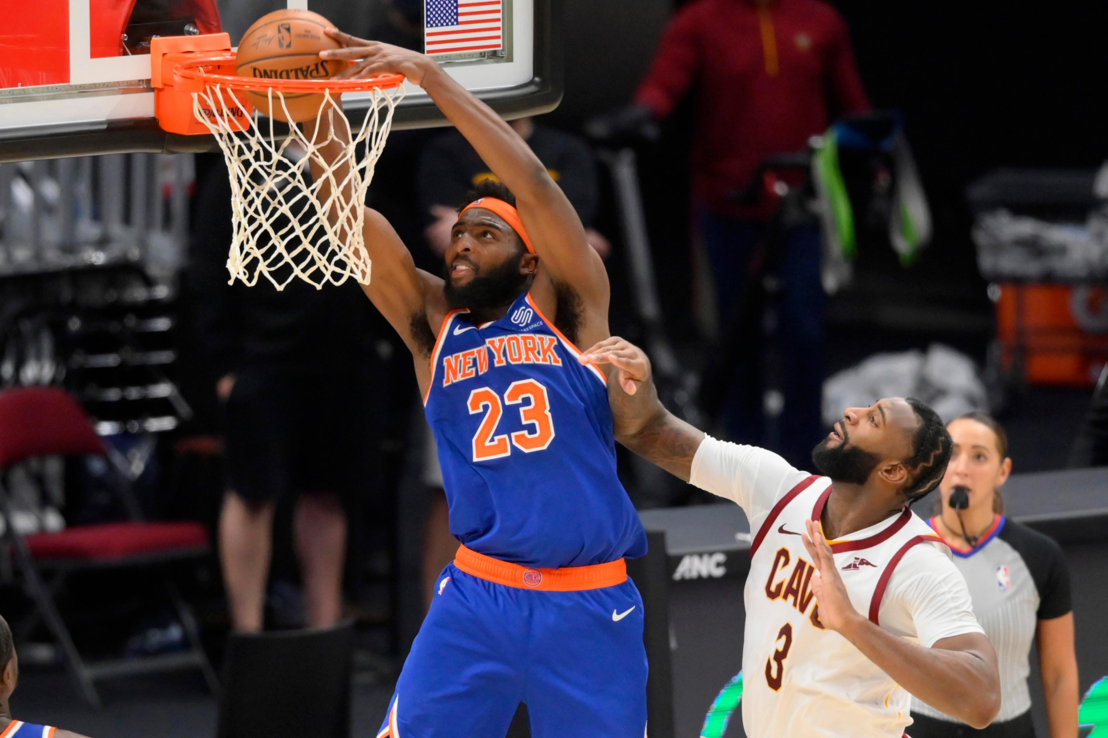 Dec 29, 2020; Cleveland, Ohio, USA; New York Knicks center Mitchell Robinson (23) dunks against Cleveland Cavaliers center Andre Drummond (3) in the fourth quarter at Rocket Mortgage FieldHouse. Mandatory Credit: David Richard-USA TODAY Sports / © David Richard-USA TODAY Sports
