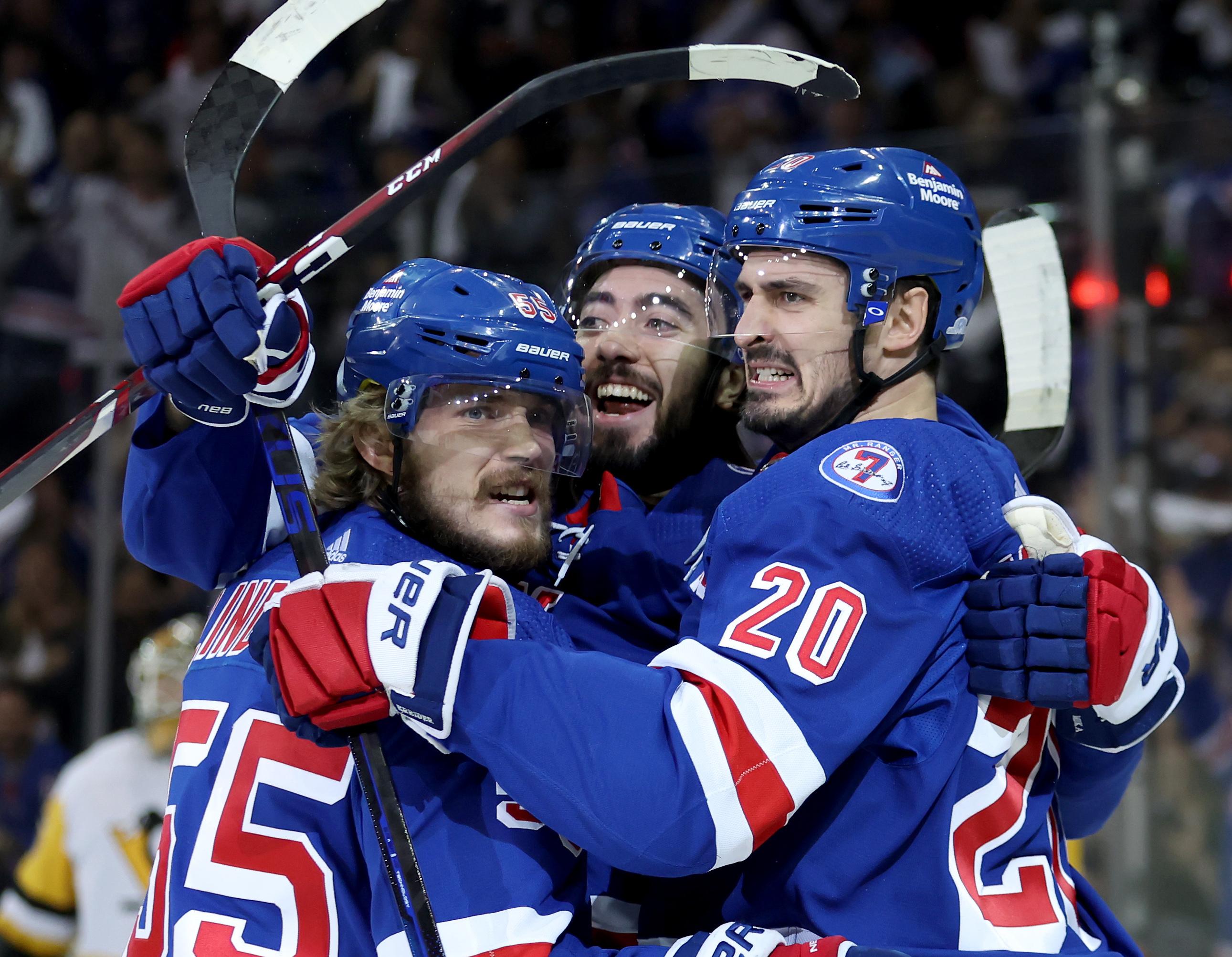 New York Rangers left wing Chris Kreider (20) celebrates his goal against the Pittsburgh Penguins with defenseman Ryan Lindgren (55) and center Mika Zibanejad (93) during the first period of game seven of the first round of the 2022 Stanley Cup Playoffs at Madison Square Garden / Brad Penner-USA TODAY Sports