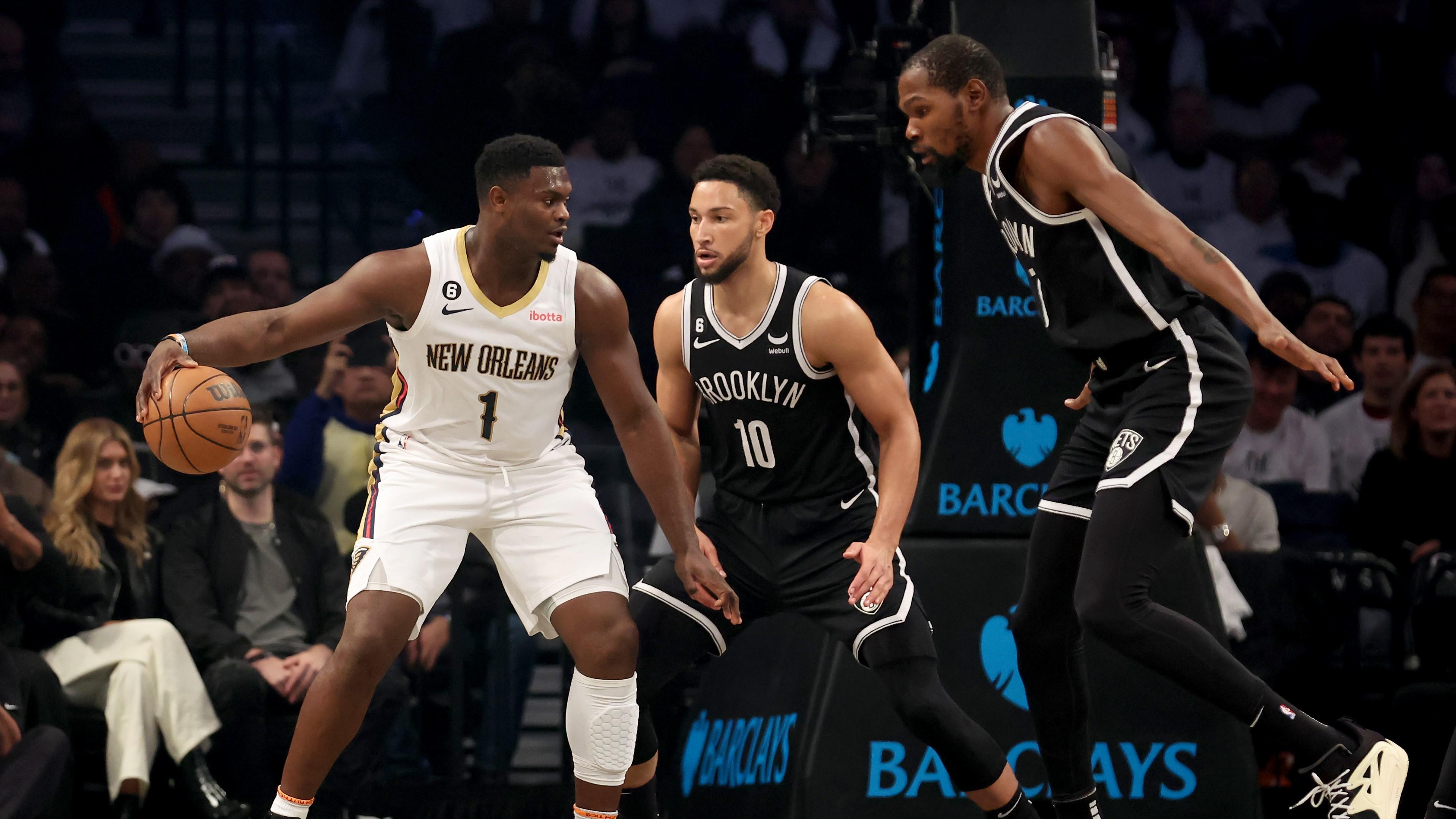 Oct 19, 2022; Brooklyn, New York, USA; New Orleans Pelicans forward Zion Williamson (1) controls the ball against Brooklyn Nets guard Ben Simmons (10) and forward Kevin Durant (7) during the first quarter at Barclays Center. Mandatory Credit: Brad Penner-USA TODAY Sports / © Brad Penner-USA TODAY Sports