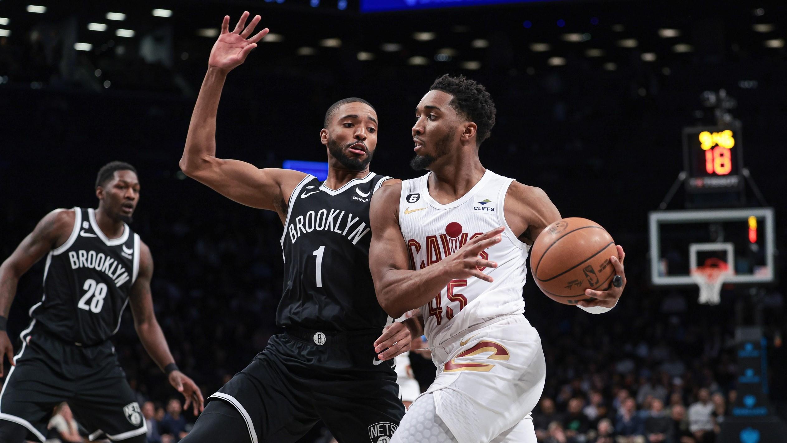 Mar 21, 2023; Brooklyn, New York, USA; Cleveland Cavaliers guard Donovan Mitchell (45) dribbles against Brooklyn Nets forward Mikal Bridges (1) during the first quarter at Barclays Center. / Vincent Carchietta-USA TODAY Sports