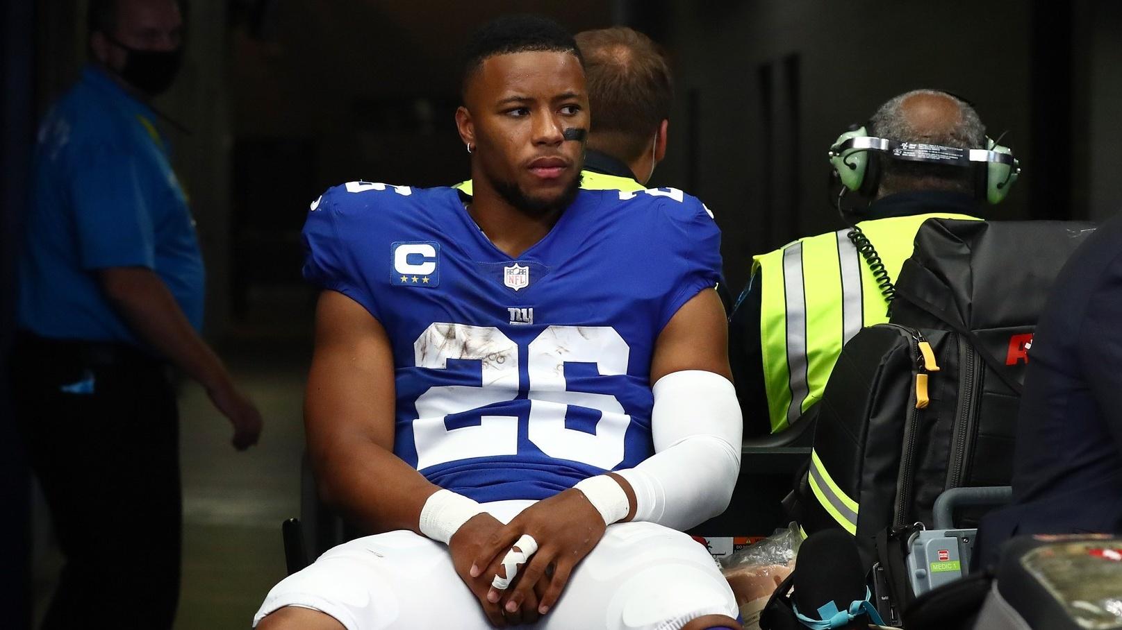 Oct 10, 2021; Arlington, Texas, USA; New York Giants running back Saquon Barkley (26) heads to the locker room on a medical cart in the first half during the game against the Dallas Cowboys at AT&T Stadium. / Matthew Emmons-USA TODAY Sports