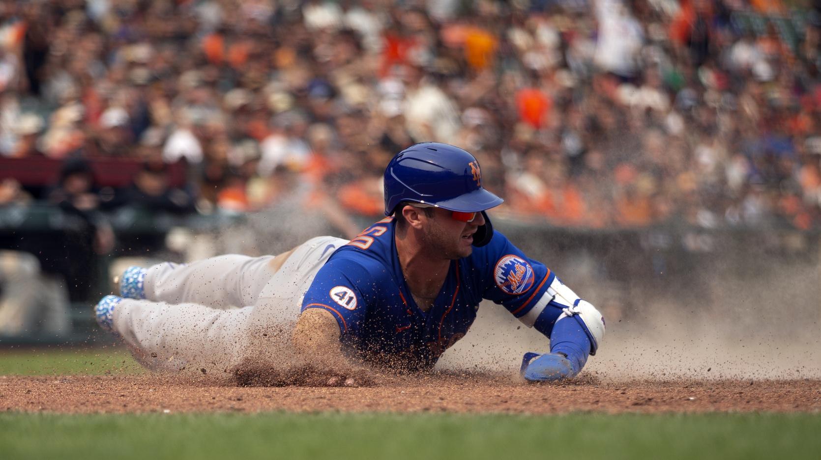 New York Mets first baseman Pete Alonso (20) slides safely home with the tying run on a sacrifice fly by third baseman J.D. Davis (28) during the ninth inning against the San Francisco Giants at Oracle Park. / D. Ross Cameron-USA TODAY Sports