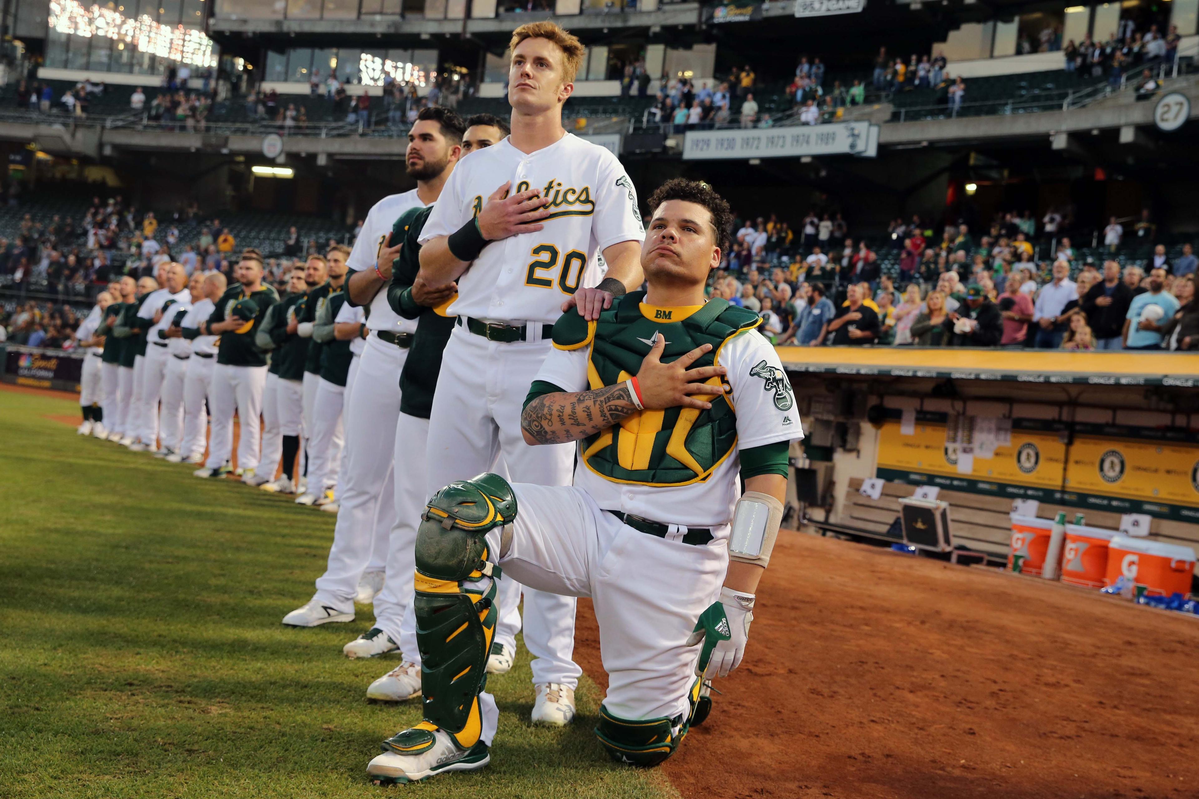 Bruce Maxwell kneels during the national anthem before a game with the Oakland A's / USA TODAY