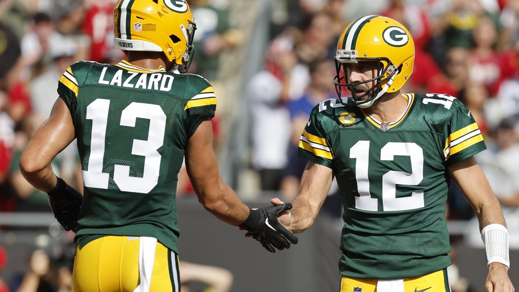 Sep 25, 2022; Tampa, Florida, USA; Green Bay Packers quarterback Aaron Rodgers (12) and wide receiver Allen Lazard (13) congratulate each other after they scored a touchdown against the Tampa Bay Buccaneers during the first quarter at Raymond James Stadium. / Kim Klement-USA TODAY Sports