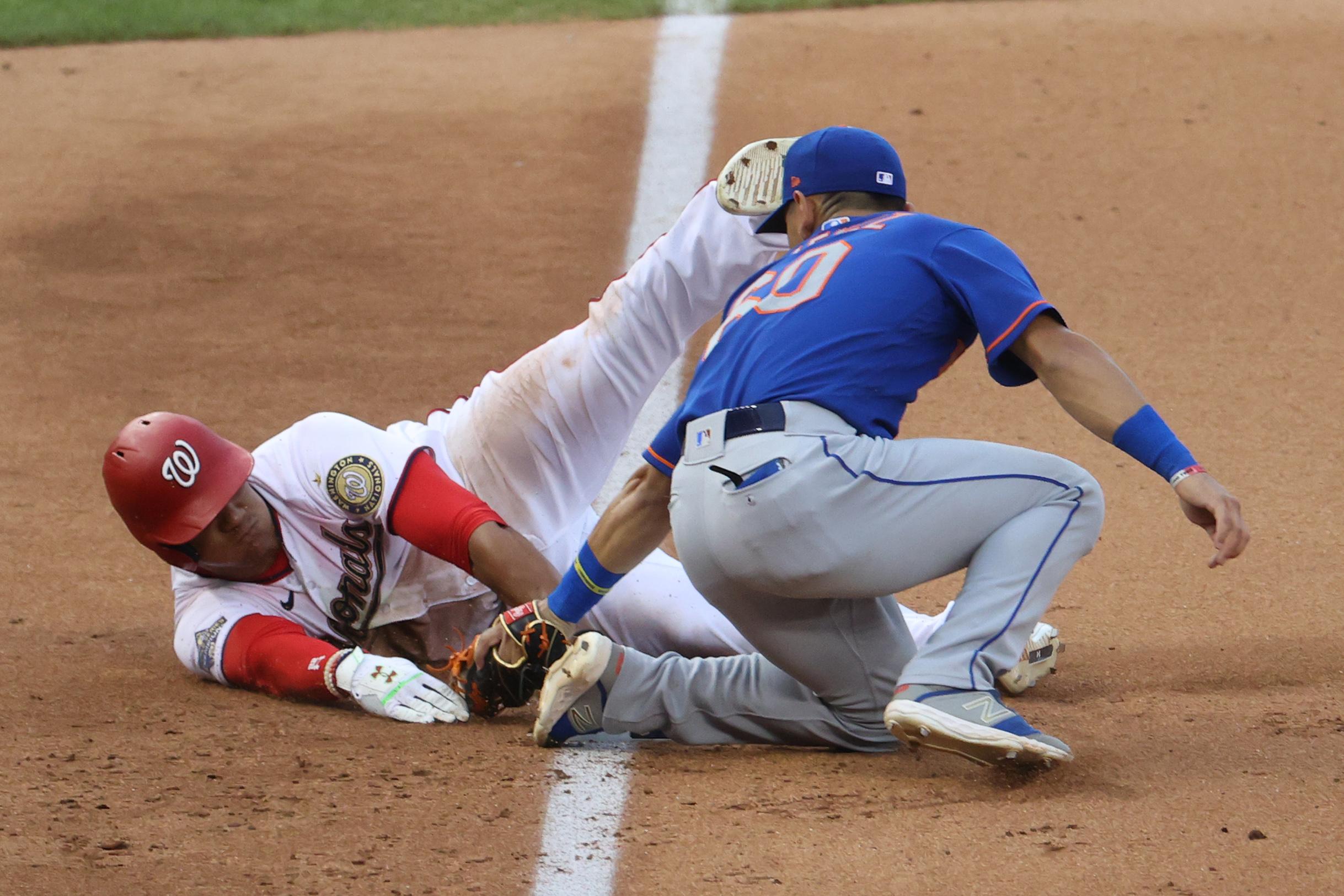 Washington Nationals left fielder Juan Soto (22) is tagged out at third base by New York Mets shortstop Andres Gimenez (60) in the fourth inning at Nationals Park. / Geoff Burke- USA TODAY Sports