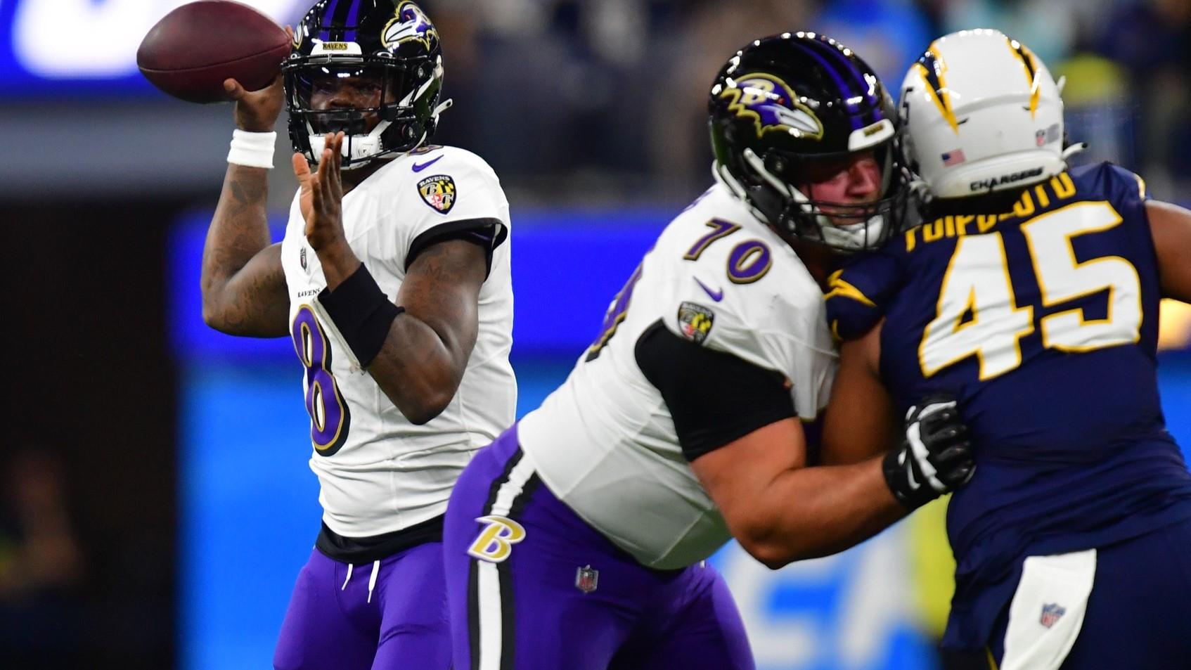 Nov 26, 2023; Inglewood, California, USA; Baltimore Ravens quarterback Lamar Jackson (8) throws as guard Kevin Zeitler (70) provides coverage against Los Angeles Chargers linebacker Tuli Tuipulotu (45) during the first half at SoFi Stadium. / Gary A. Vasquez-USA TODAY Sports