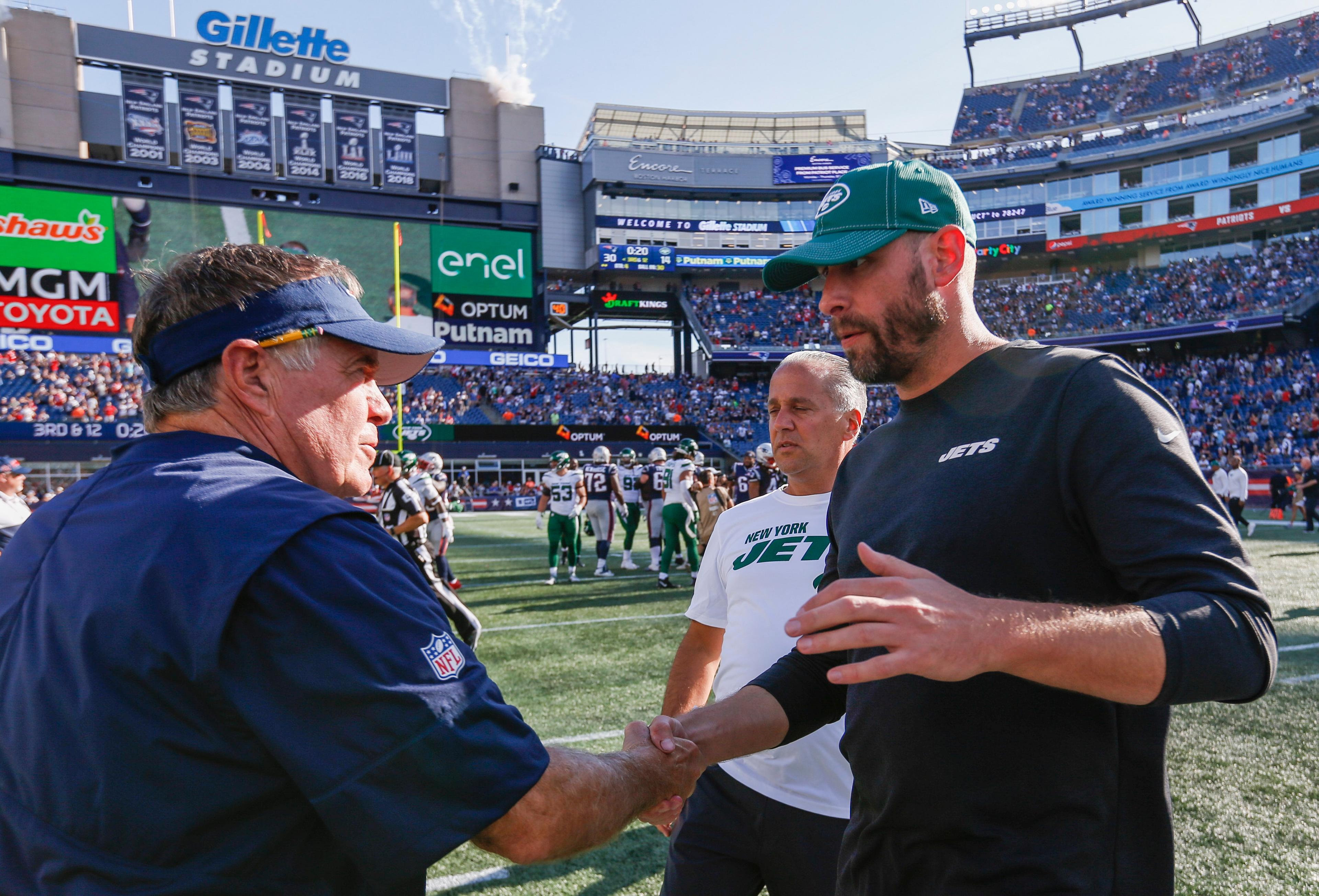 Sep 22, 2019; Foxborough, MA, USA; New England Patriots head coach Bill Belichick greets New York Jets head coach Adam Gase after the game at Gillette Stadium. / Greg M. Cooper-USA TODAY Sports
