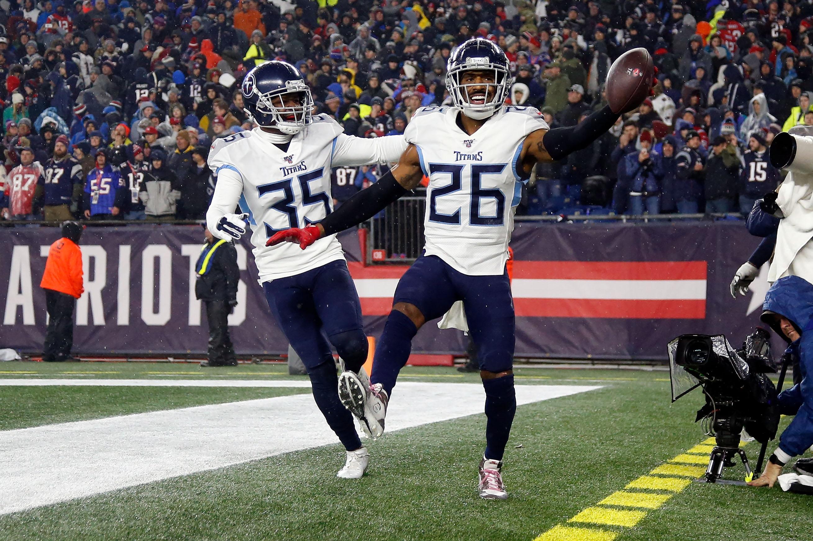 Jan 4, 2020; Foxborough, Massachusetts, USA; Tennessee Titans cornerback Logan Ryan (26) celebrates with defensive back Tramaine Brock (35) after scoring a touchdown on an interception against the New England Patriots during the second half at Gillette Stadium. Mandatory Credit: Winslow Townson-USA TODAY Sports / © Winslow Townson-USA TODAY Sports