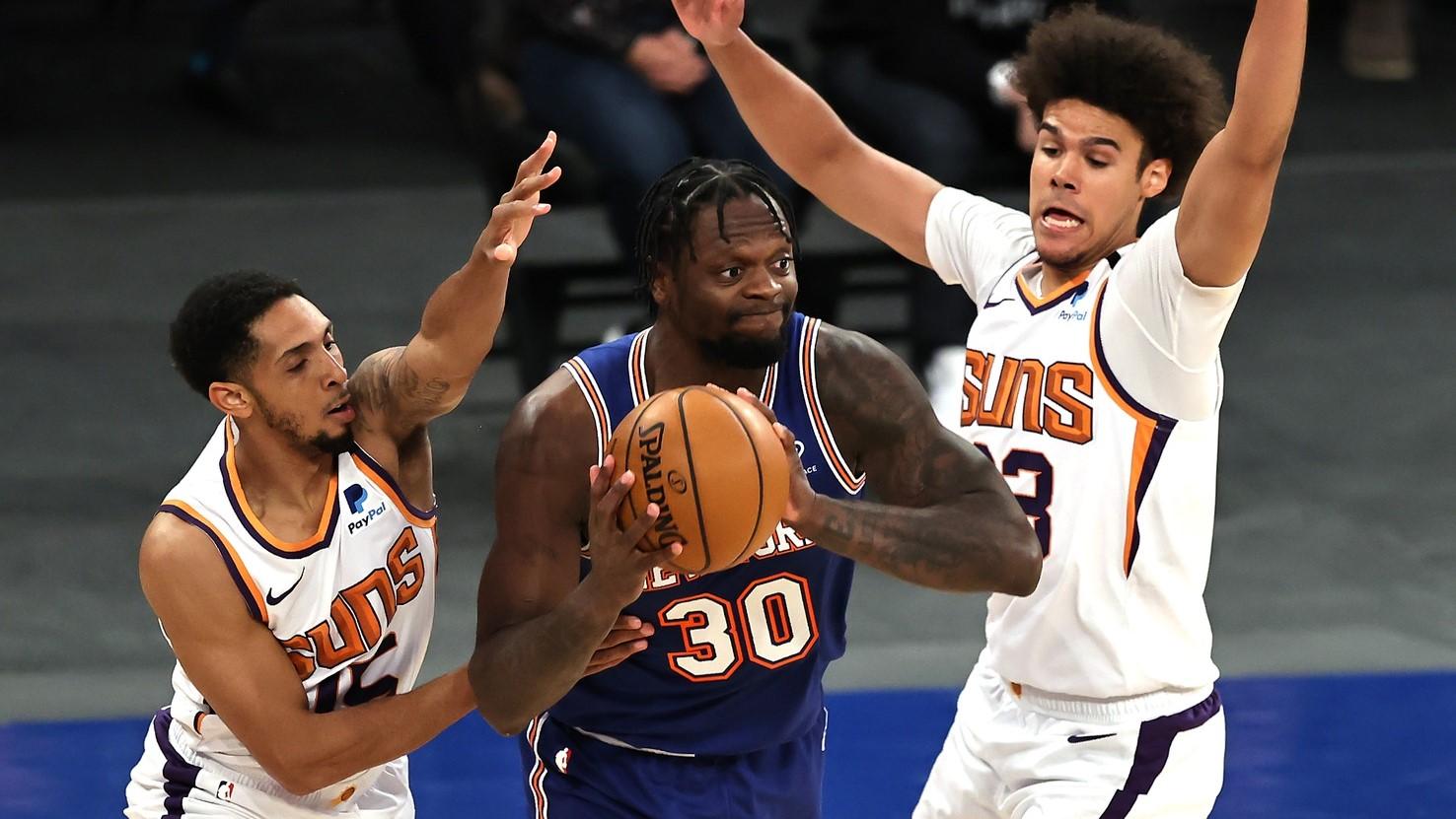 Apr 26, 2021; New York, New York, USA; Julius Randle #30 of the New York Knicks looks to pass as Cameron Payne #15 and Cameron Johnson #23 of the Phoenix Suns defend in the first half at Madison Square Garden. / Elsa/POOL PHOTOS-USA TODAY Sports