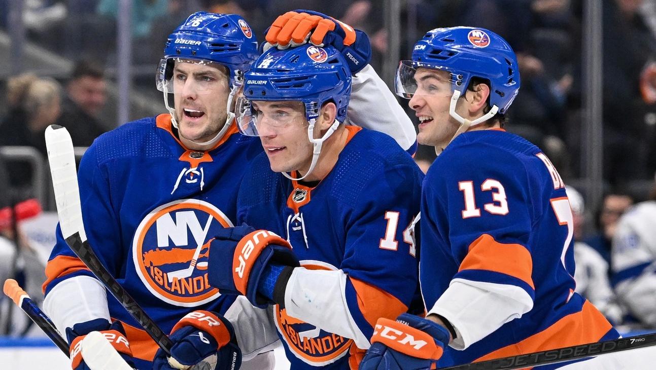 New York Islanders defenseman Ryan Pulock (6) and New York Islanders center Mathew Barzal (13) celebrate the goal by New York Islanders center Bo Horvat (14) against the Tampa Bay Lightning during the second period at UBS Arena. / Dennis Schneidler-USA TODAY Sports