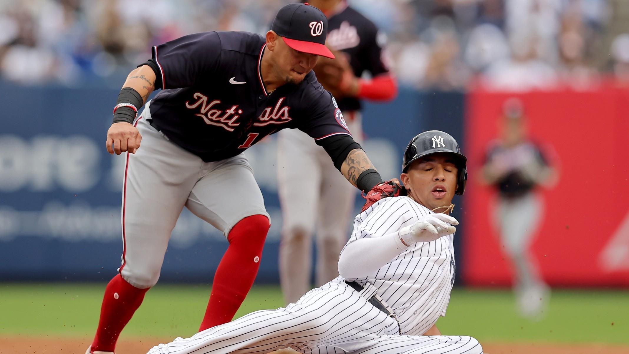 New York Yankees third baseman Oswald Peraza (91) is tagged out by Washington Nationals second baseman Ildemaro Vargas (14) in a rundown after being picked off first base during the second inning at Yankee Stadium. / Brad Penner-USA TODAY Sports