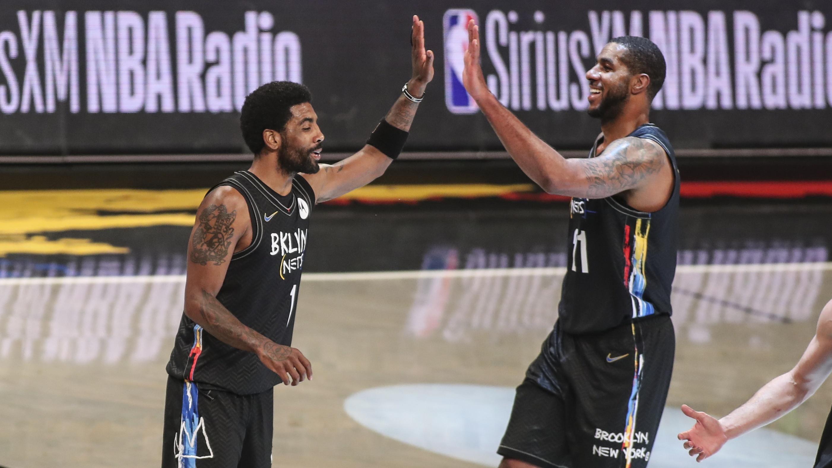 Apr 7, 2021; Brooklyn, New York, USA; Brooklyn Nets guard Kyrie Irving (11) and center LaMarcus Aldridge (21) celebrate during a time out in the third quarter against the New Orleans Pelicans at Barclays Center. / © Wendell Cruz-USA TODAY Sports