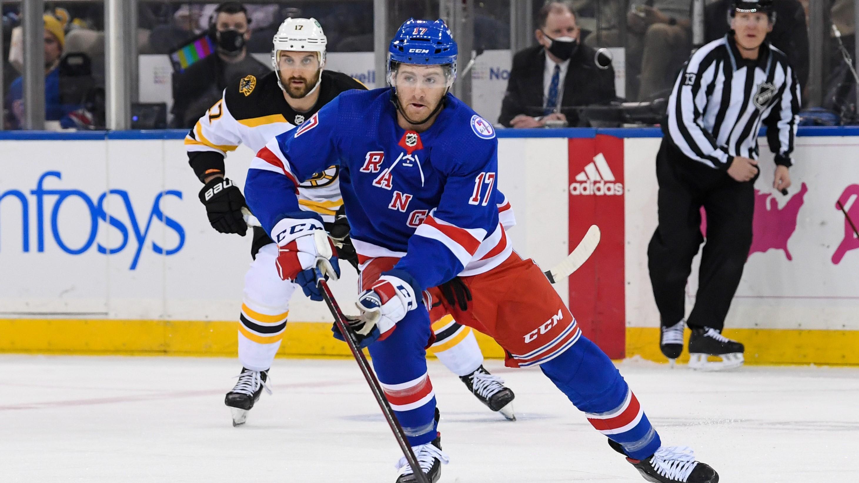 New York Rangers center Kevin Rooney (17) skates the puck into the zone against the Boston Bruins during the first period at Madison Square Garden. / Dennis Schneidler-USA TODAY Sports