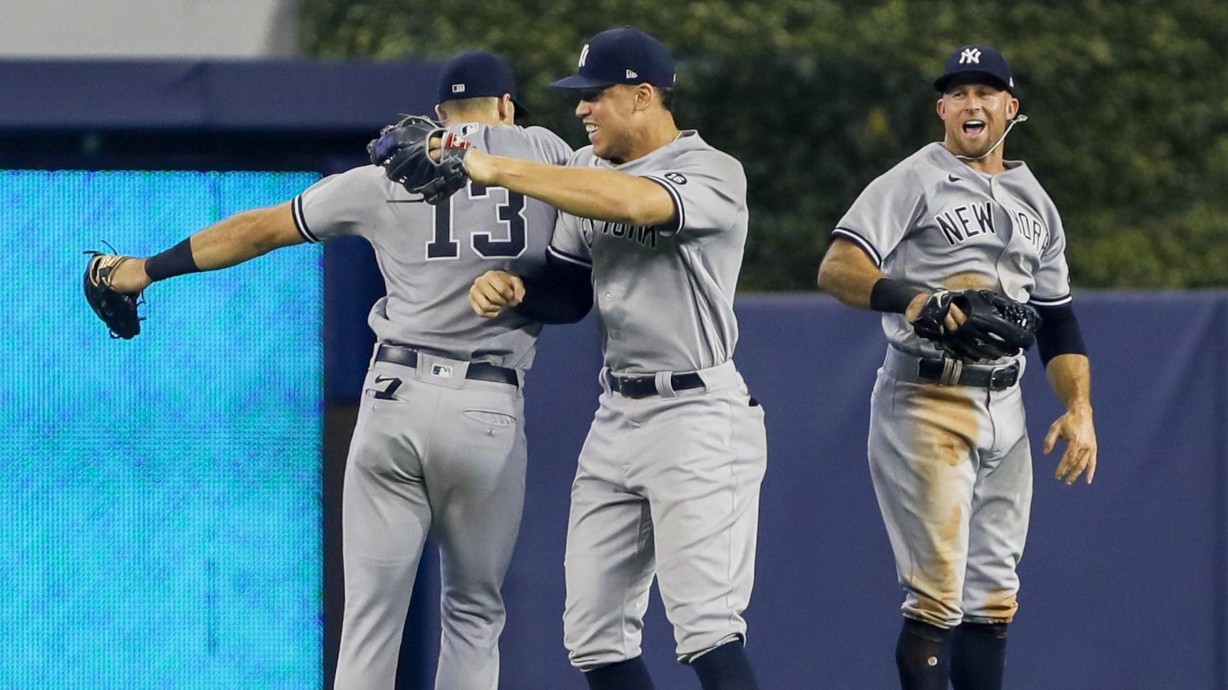 Aug 1, 2021; Miami, Florida, USA; New York Yankees center fielder Joey Gallo (13), and right fielder Aaron Judge (99) and left fielder Brett Gardner (11) celebrate after winning the game against the Miami Marlins at loanDepot Park. Mandatory Credit: Sam Navarro-USA TODAY Sports / © Sam Navarro-USA TODAY Sports