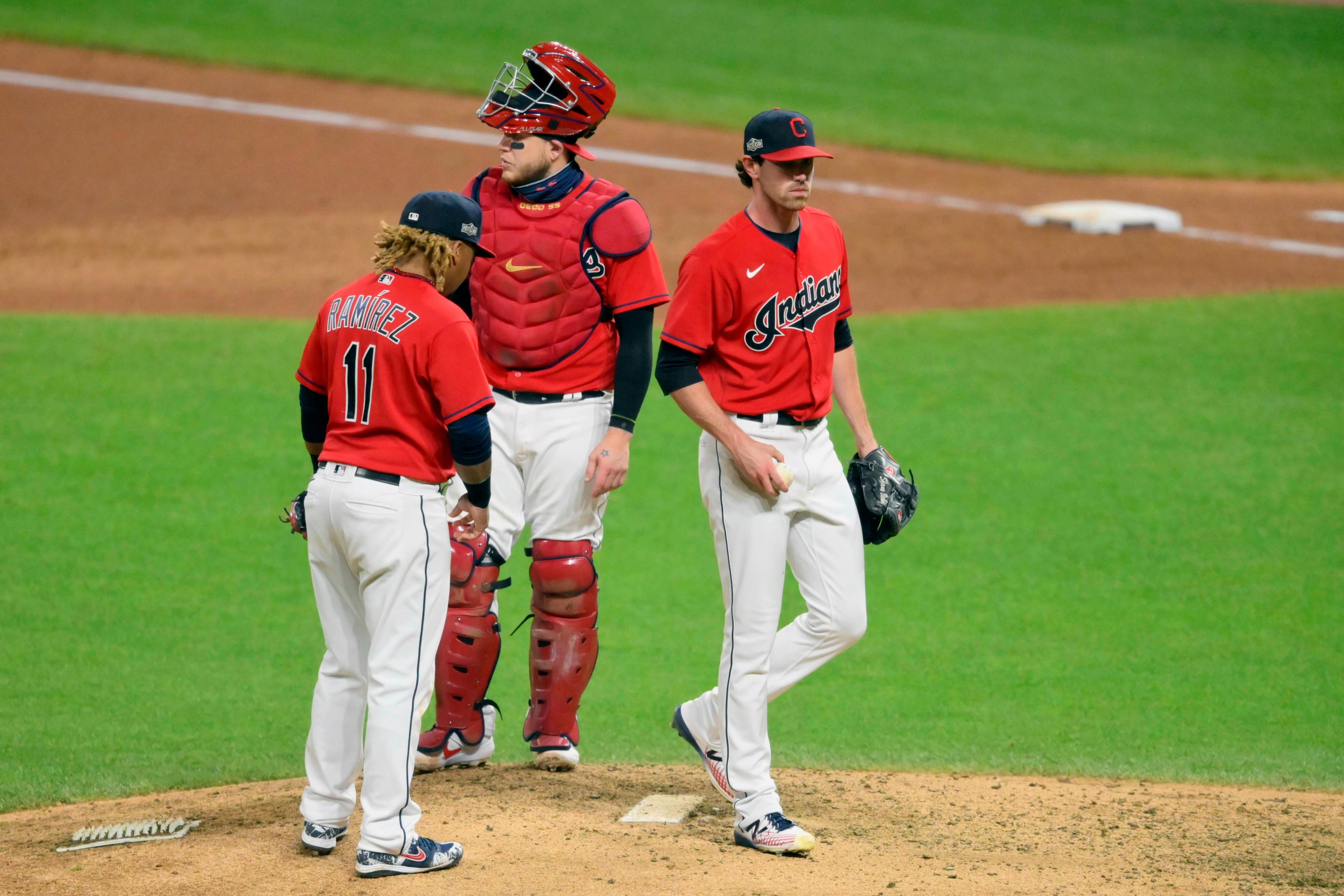 Sep 29, 2020; Cleveland, Ohio, USA; Cleveland Indians third baseman Jose Ramirez (11) and catcher Roberto Perez (middle) react as starting pitcher Shane Bieber (right) walks off the mound during a pitching change in the fifth inning against the New York Yankees at Progressive Field. Mandatory Credit: David Richard-USA TODAY Sports / © David Richard-USA TODAY Sports