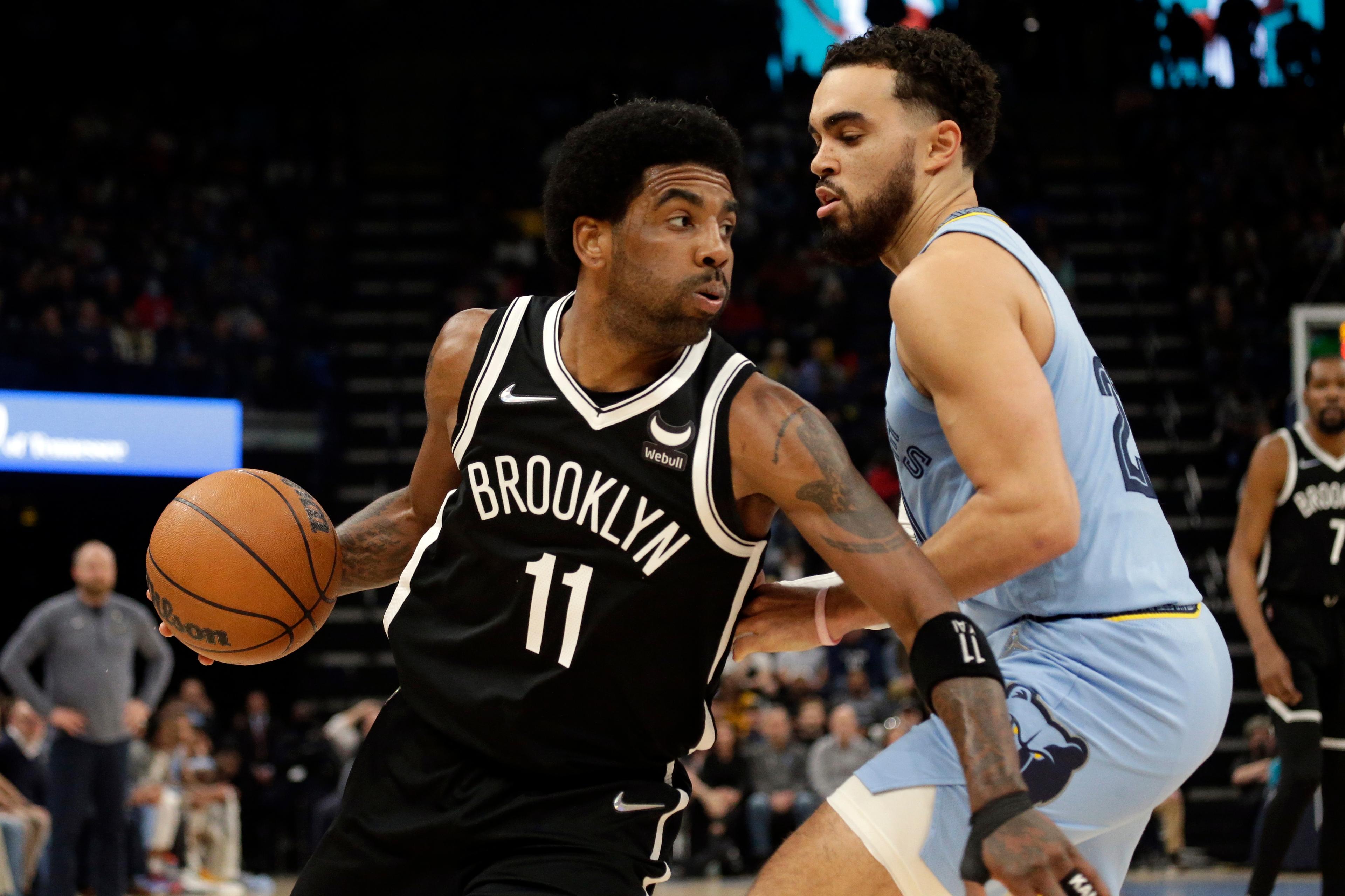Brooklyn Nets guard Kyrie Irving (11) drives to the basket as Memphis Grizzlies guard Tyus Jones (21) defends during the first half at FedExForum. / Petre Thomas-USA TODAY Sports