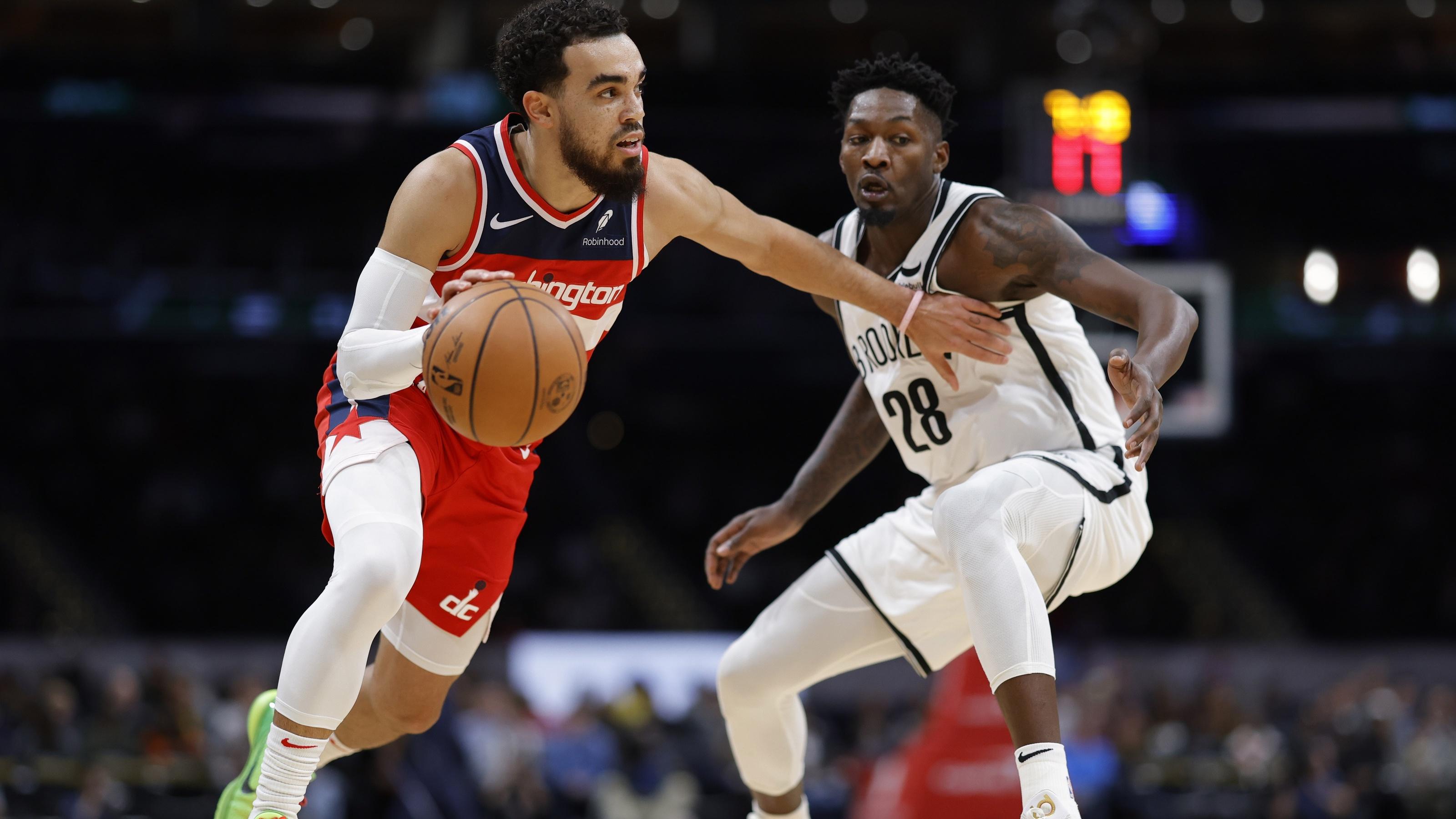 Washington Wizards guard Tyus Jones (5) drives to the basket as Brooklyn Nets forward Dorian Finney-Smith (28) defends in the first quarter at Capital One Arena. / Geoff Burke-USA TODAY Sports