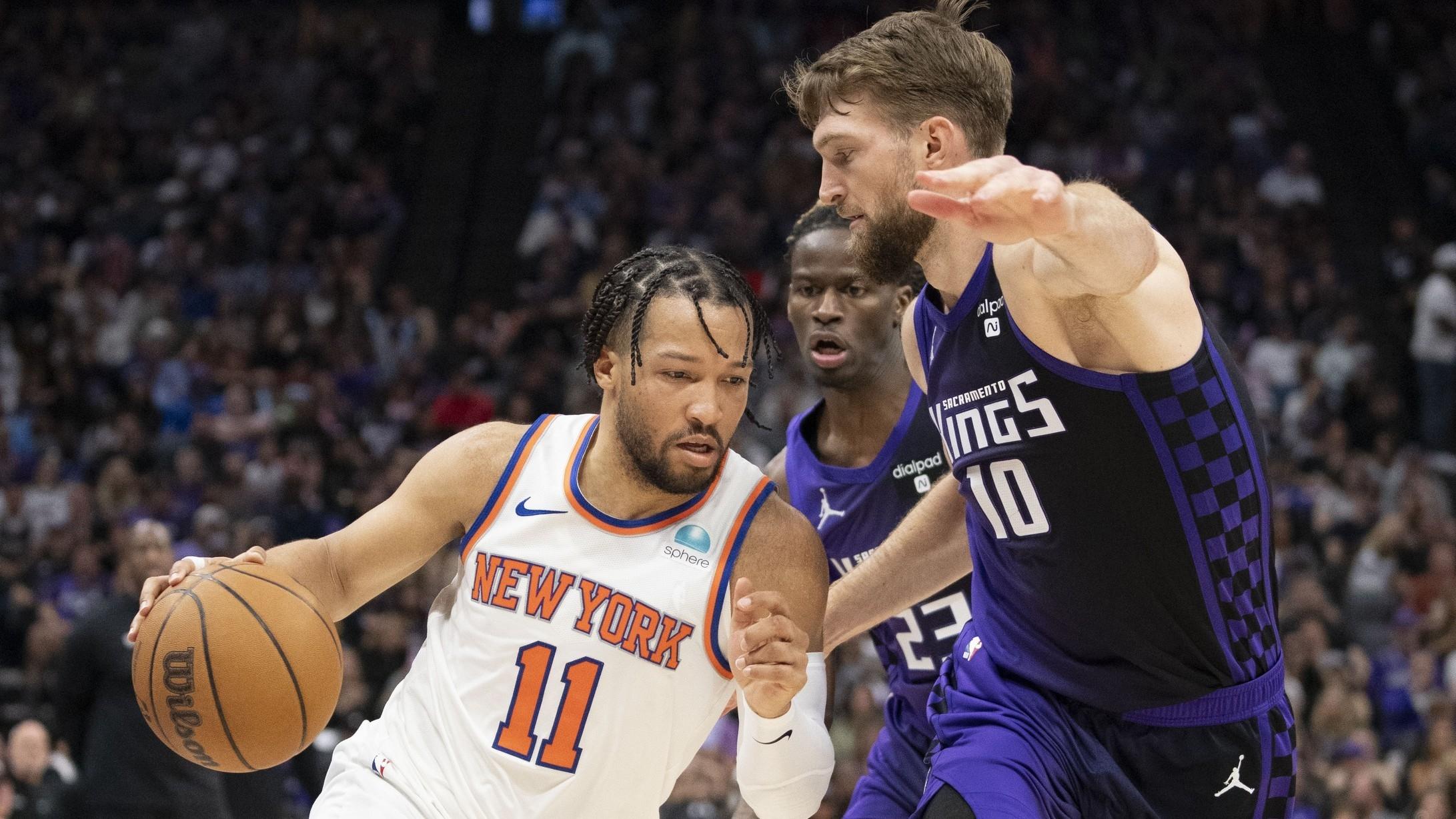 New York Knicks guard Jalen Brunson (11) dribbles the basketball against Sacramento Kings forward Domantas Sabonis (10) during the second quarter at Golden 1 Center. / Kyle Terada-USA TODAY Sports
